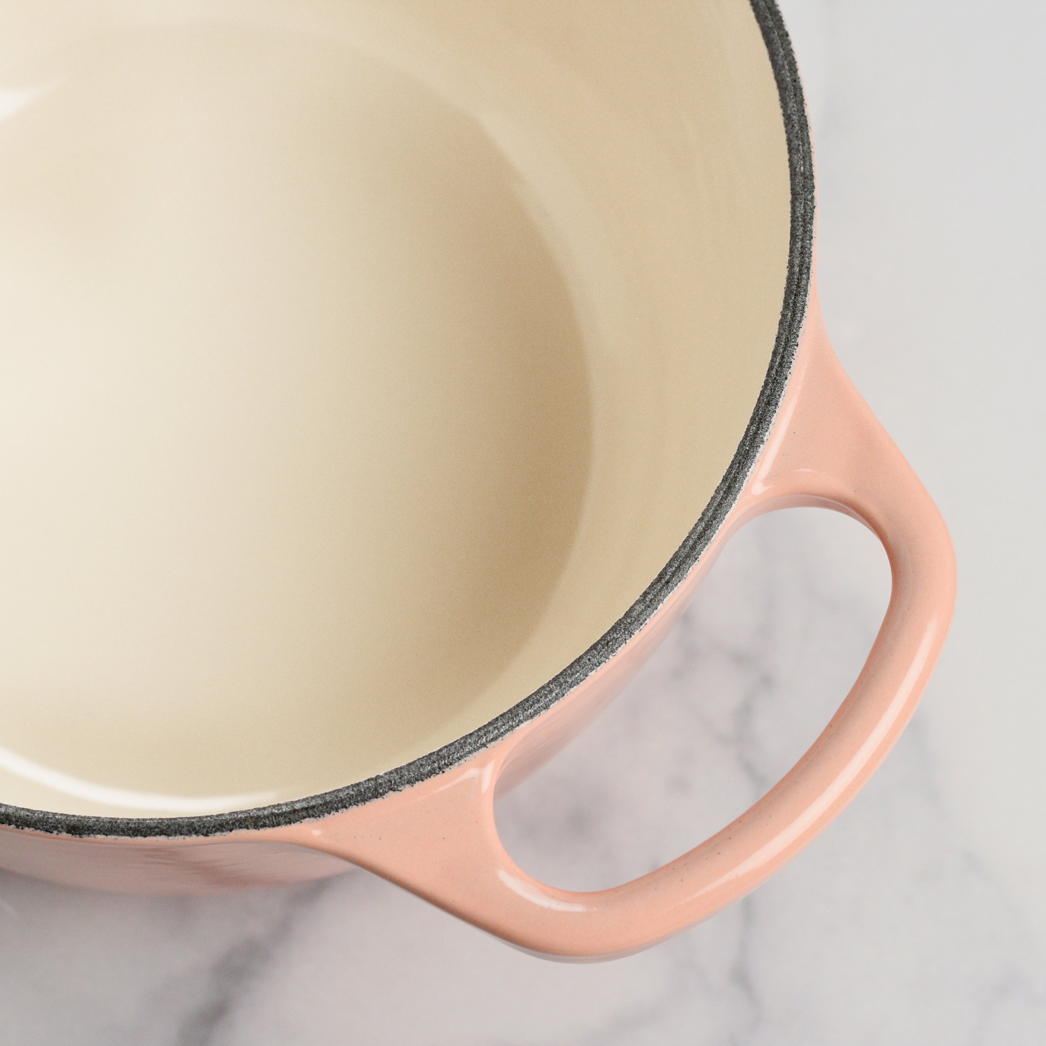 Enameled saucepan used for making sauces on induction cooktop, highlighting even heat distribution.