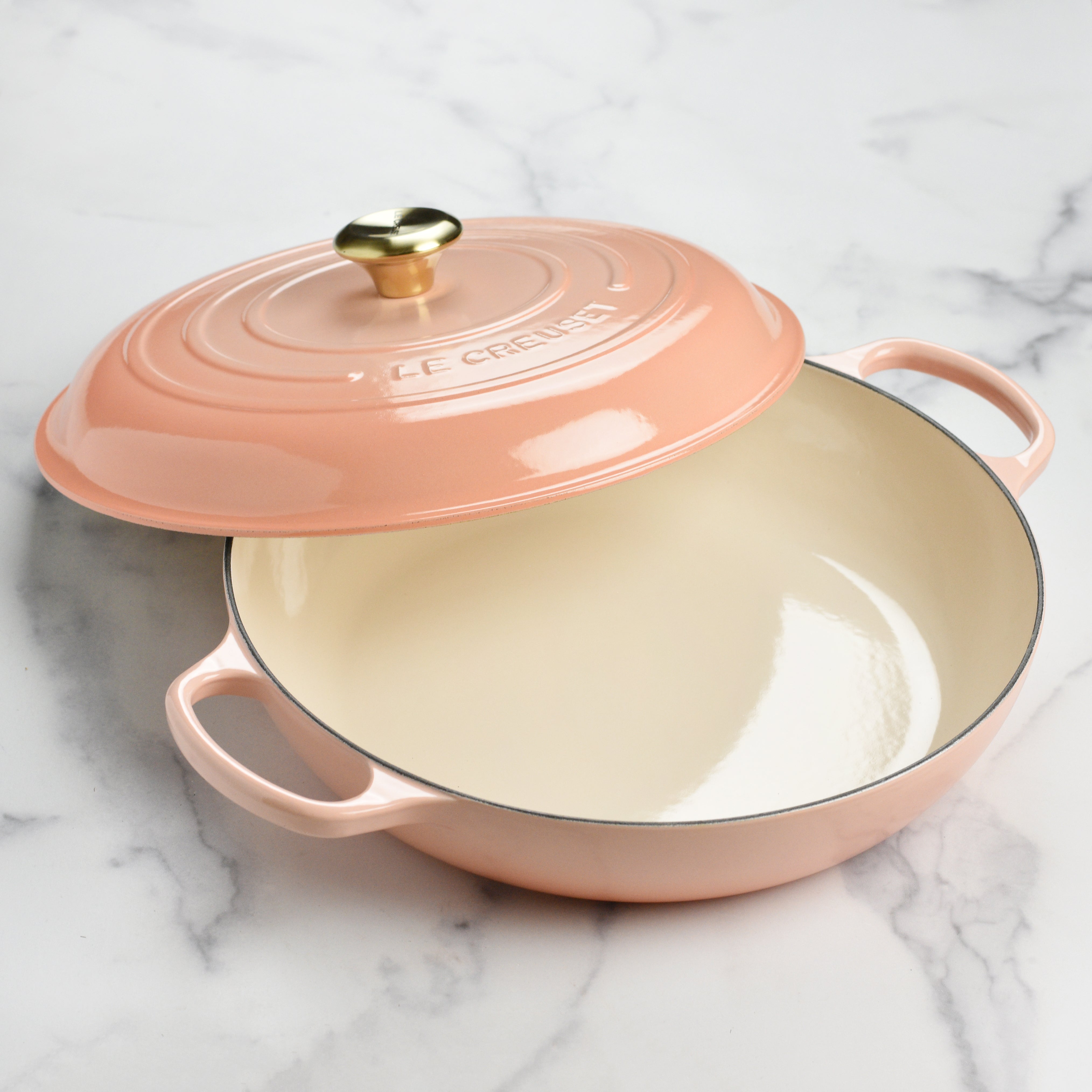 The interior of the Le Creuset braiser, highlighting the smooth enamel surface for easy cleaning.