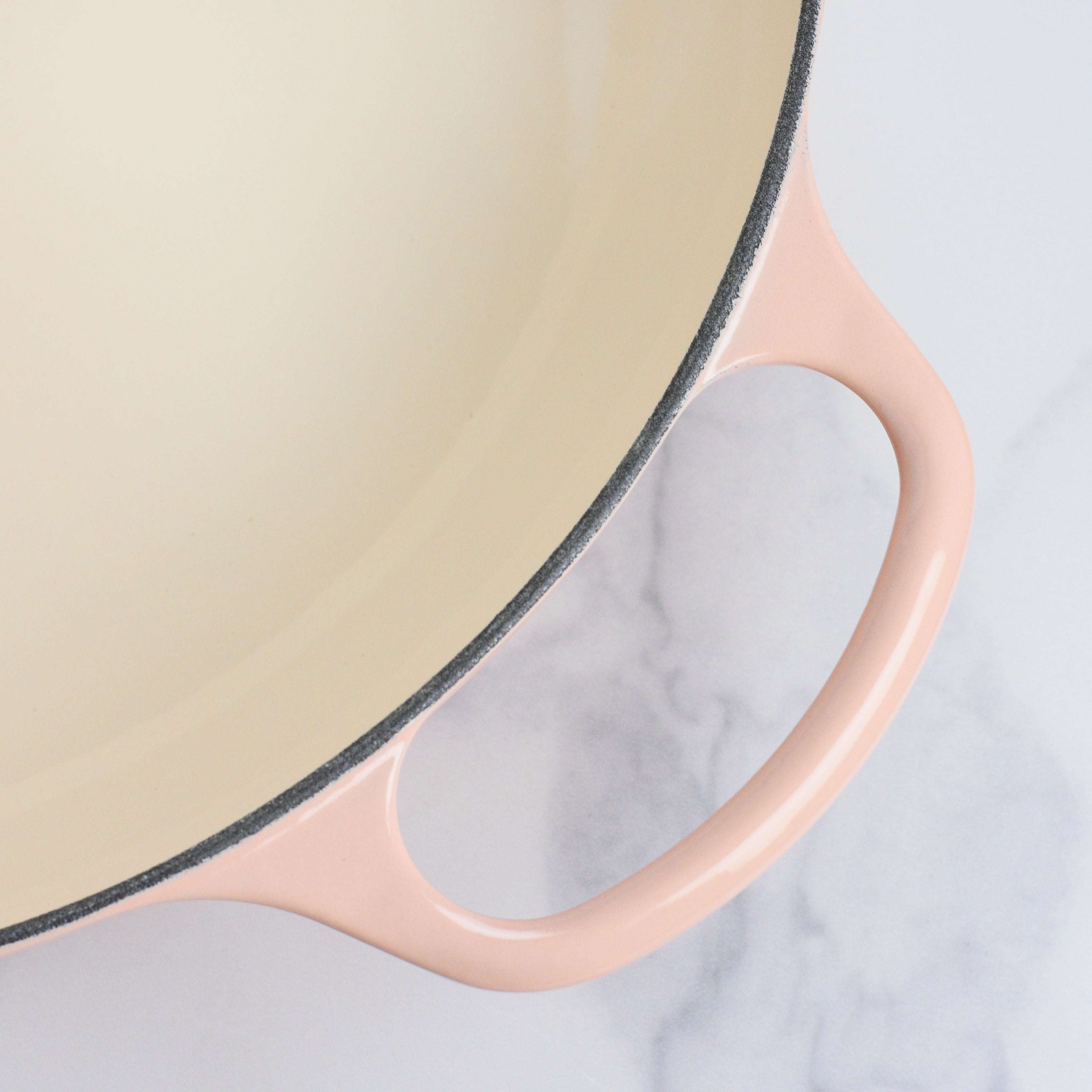 Le Creuset 5-quart cast iron braiser in Peche, showcasing the ergonomic handles and lid design.