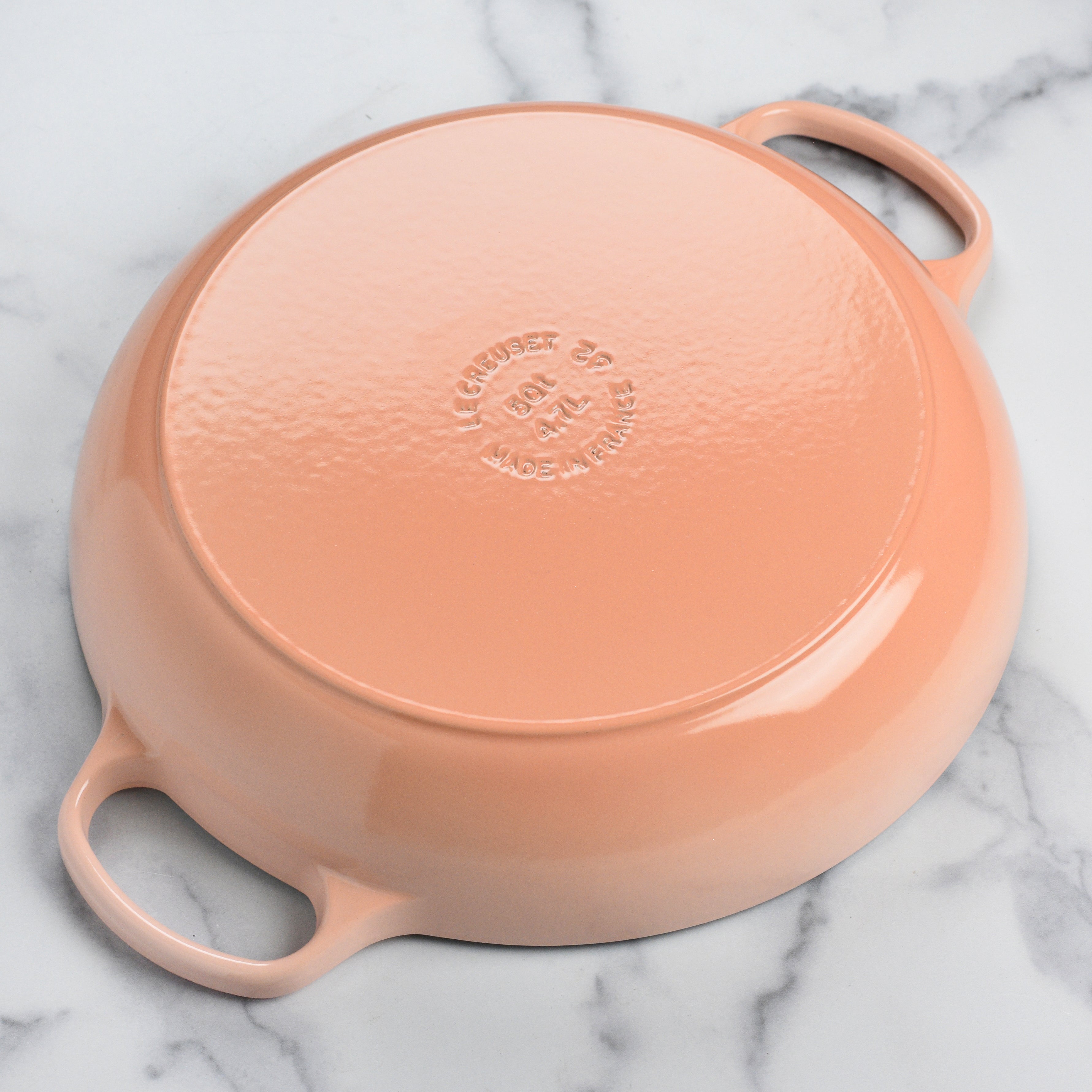 Le Creuset 5-quart cast iron braiser in Peche, showcasing the ergonomic handles and lid design.