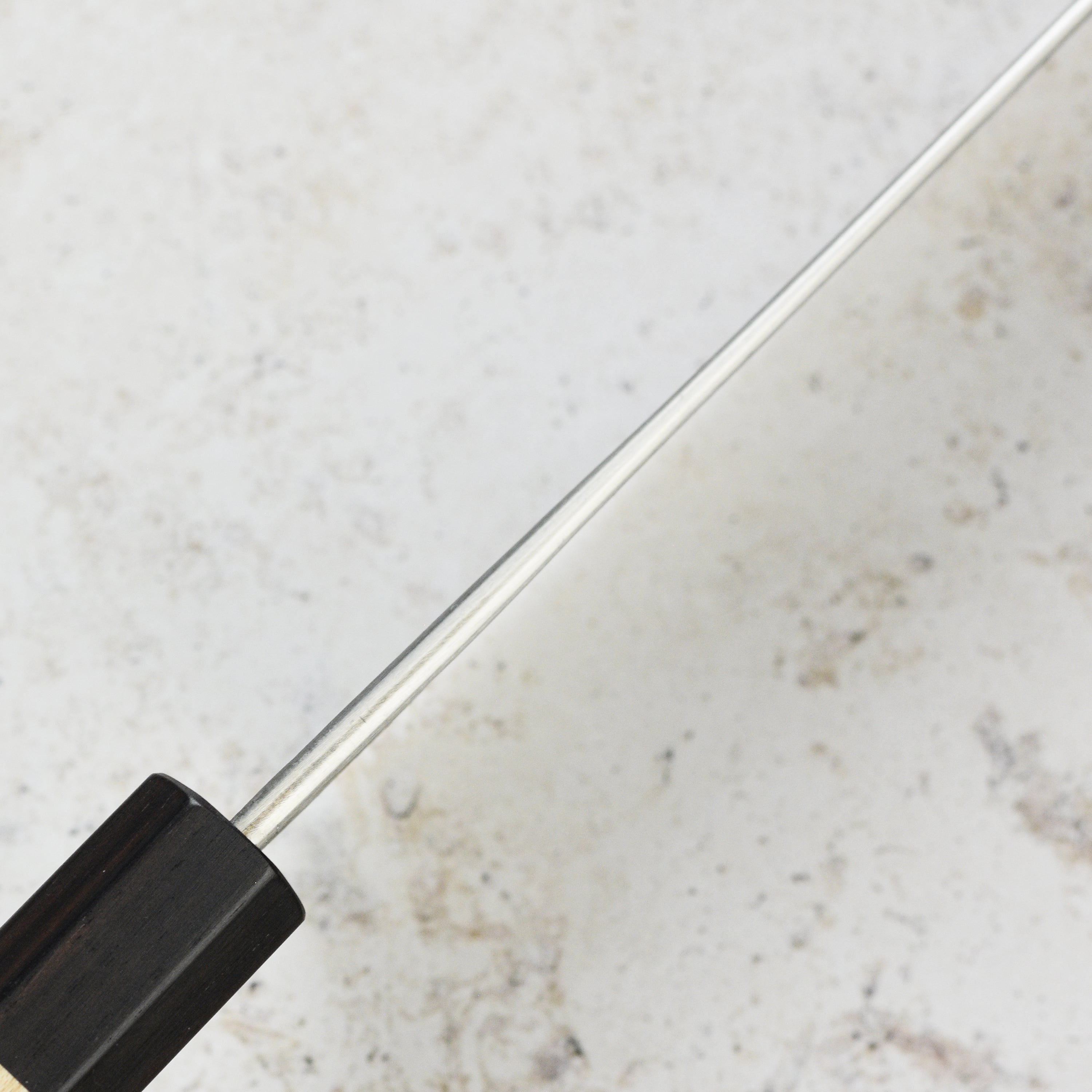Matsubara Nakiri knife on a wooden cutting board, highlighting its stainless steel finish.
