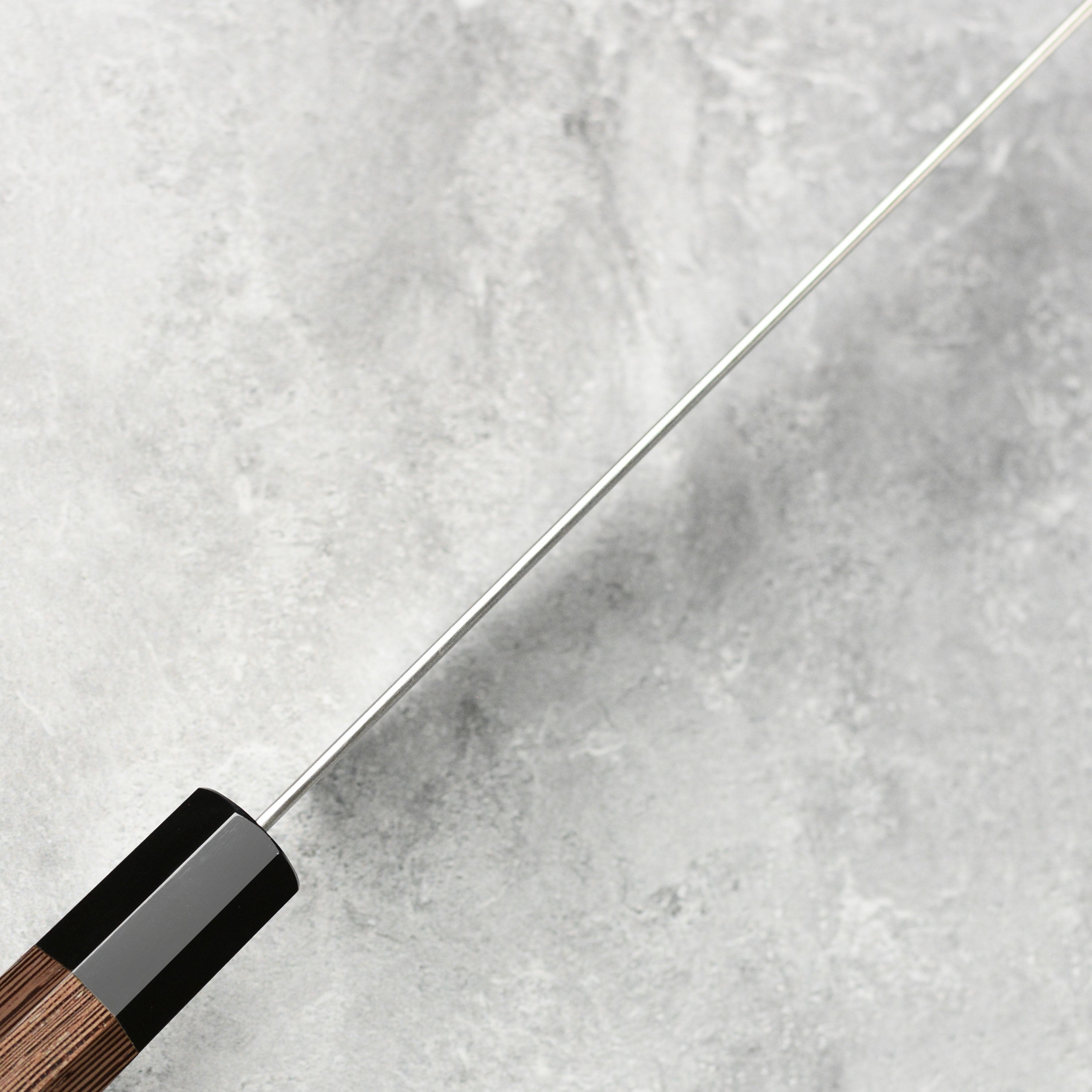 Professional-grade gyuto knife on a cutting board, ready for use