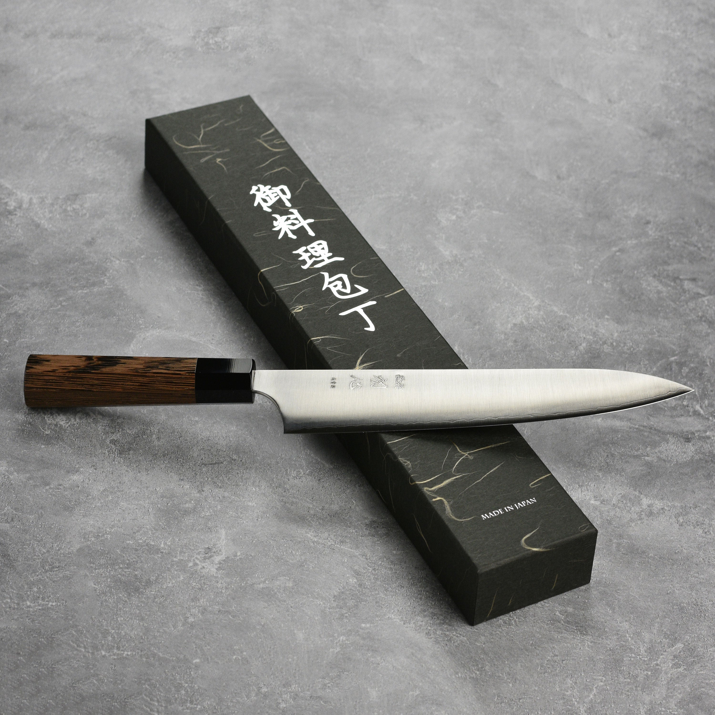 Professional-grade gyuto knife on a cutting board, ready for use