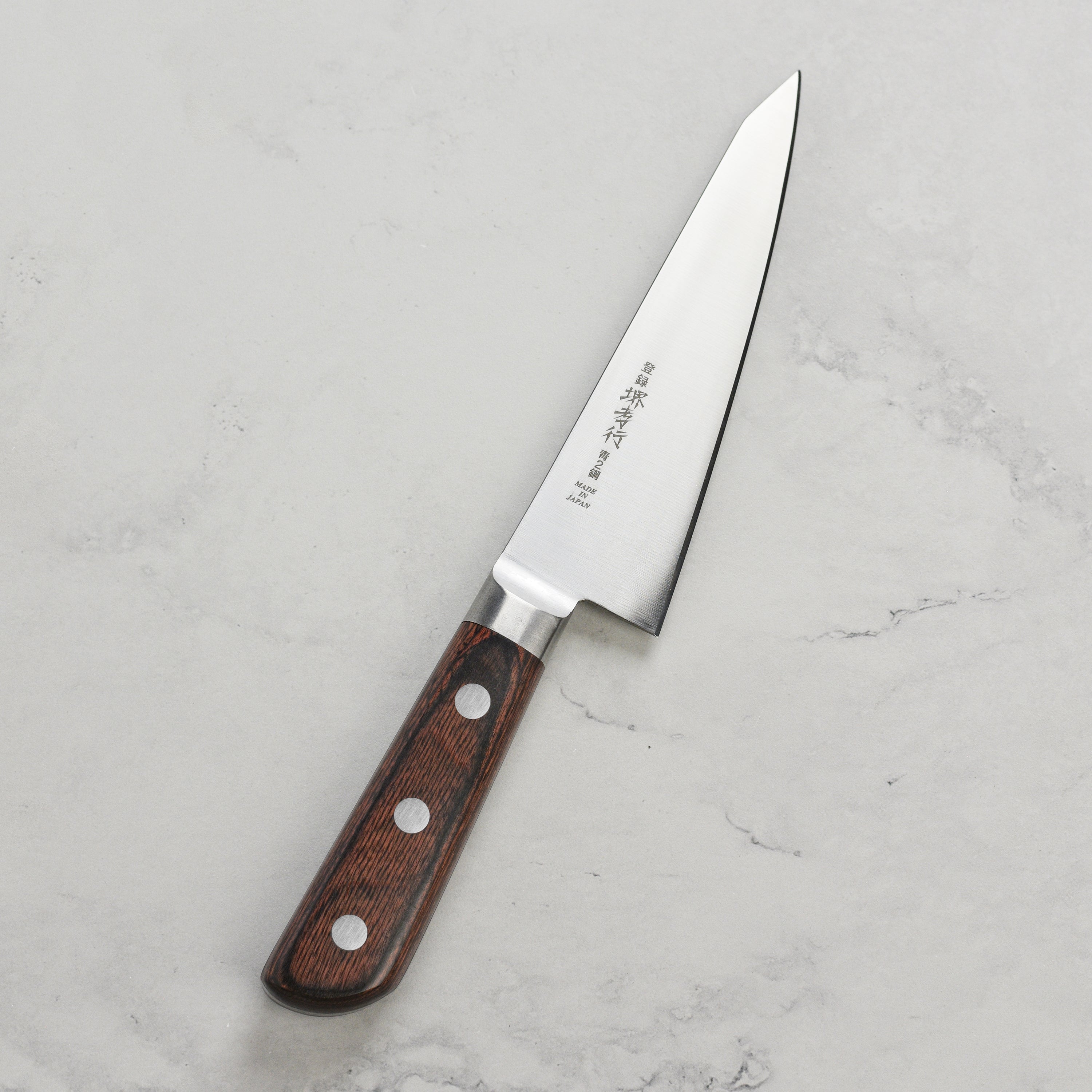 Takayuki Aogami Honesuki knife showing the carbon steel blade and ergonomic handle.