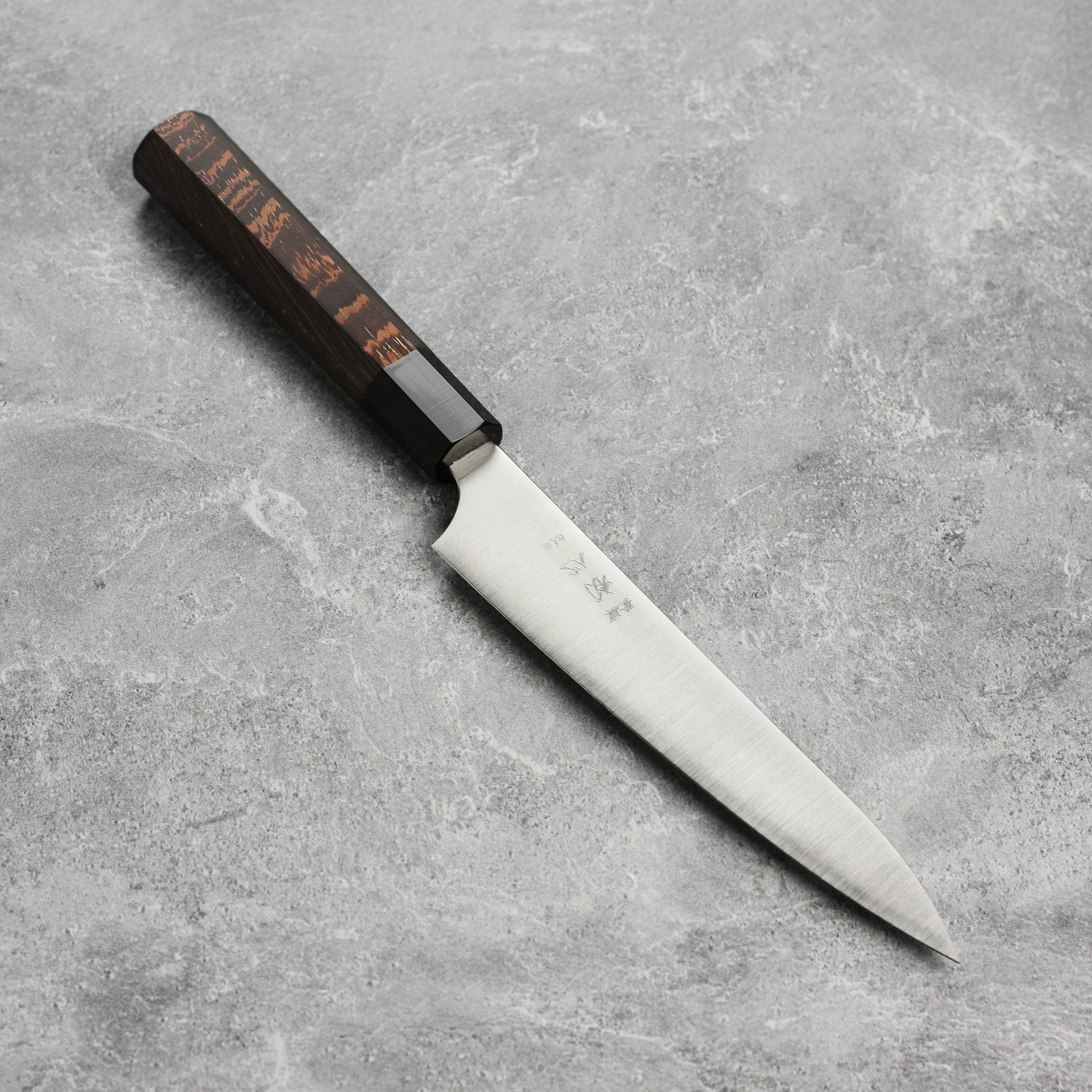 Hatsukokoro Aogami Super petty knife with a beautiful wooden handle, perfect for slicing vegetables.