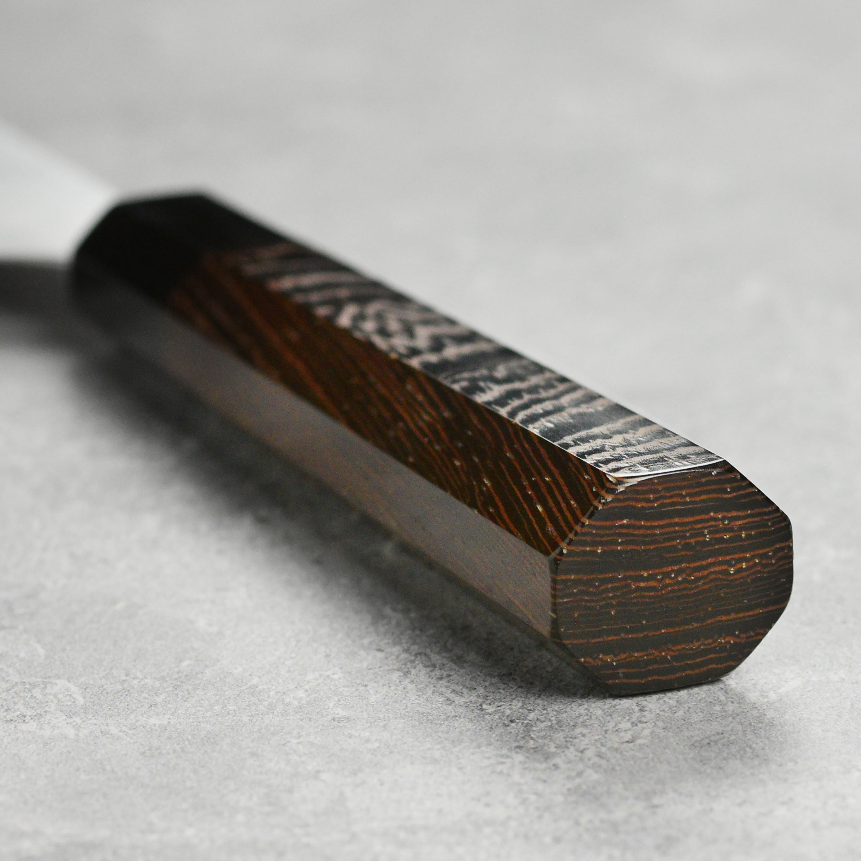 Close-up view of the Hatsukokoro Aogami Super petty knife blade, highlighting its sharp edge and craftsmanship.