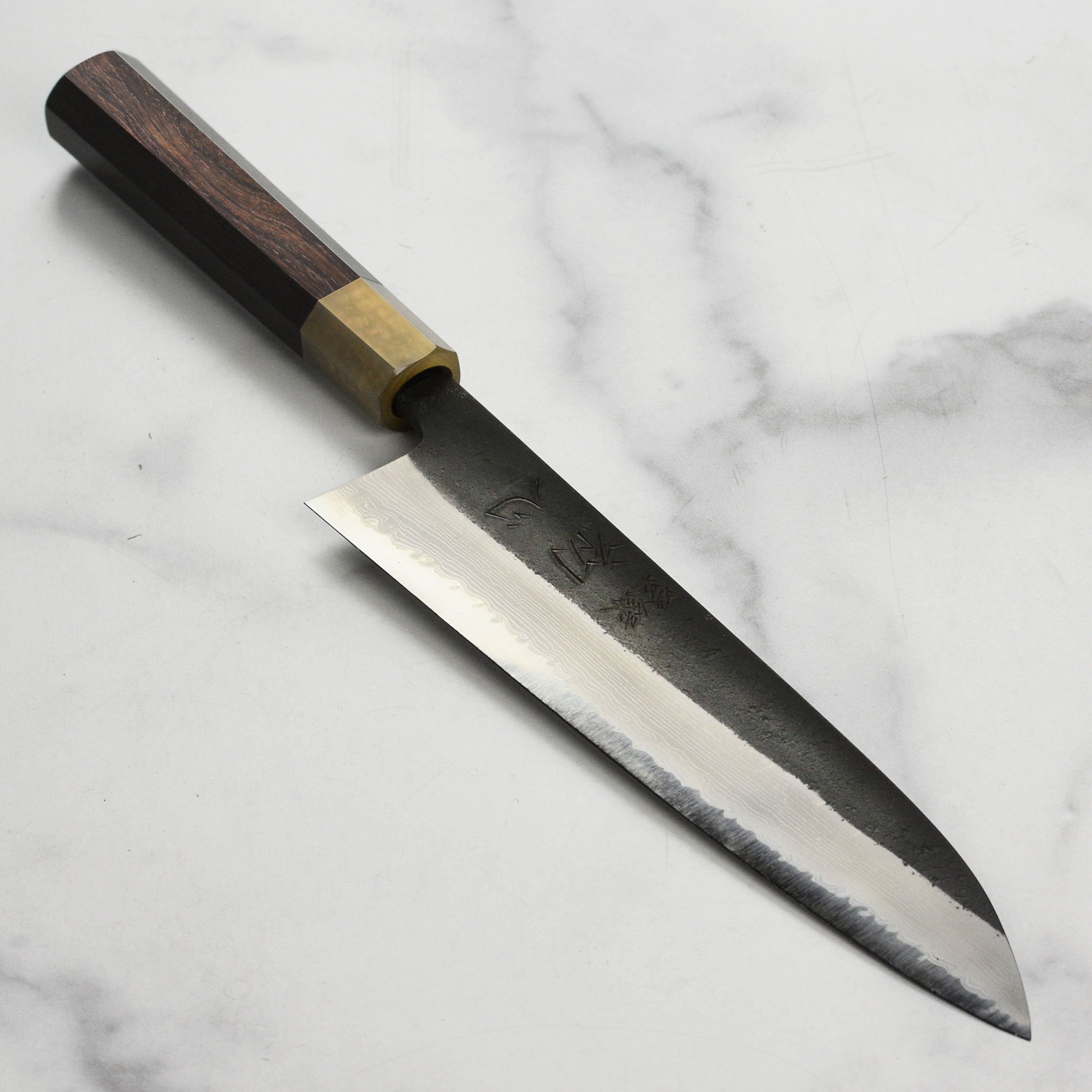 Close-up of the Hatsukokoro Shinkiro Gyuto Knife blade highlighting the Damascus pattern.