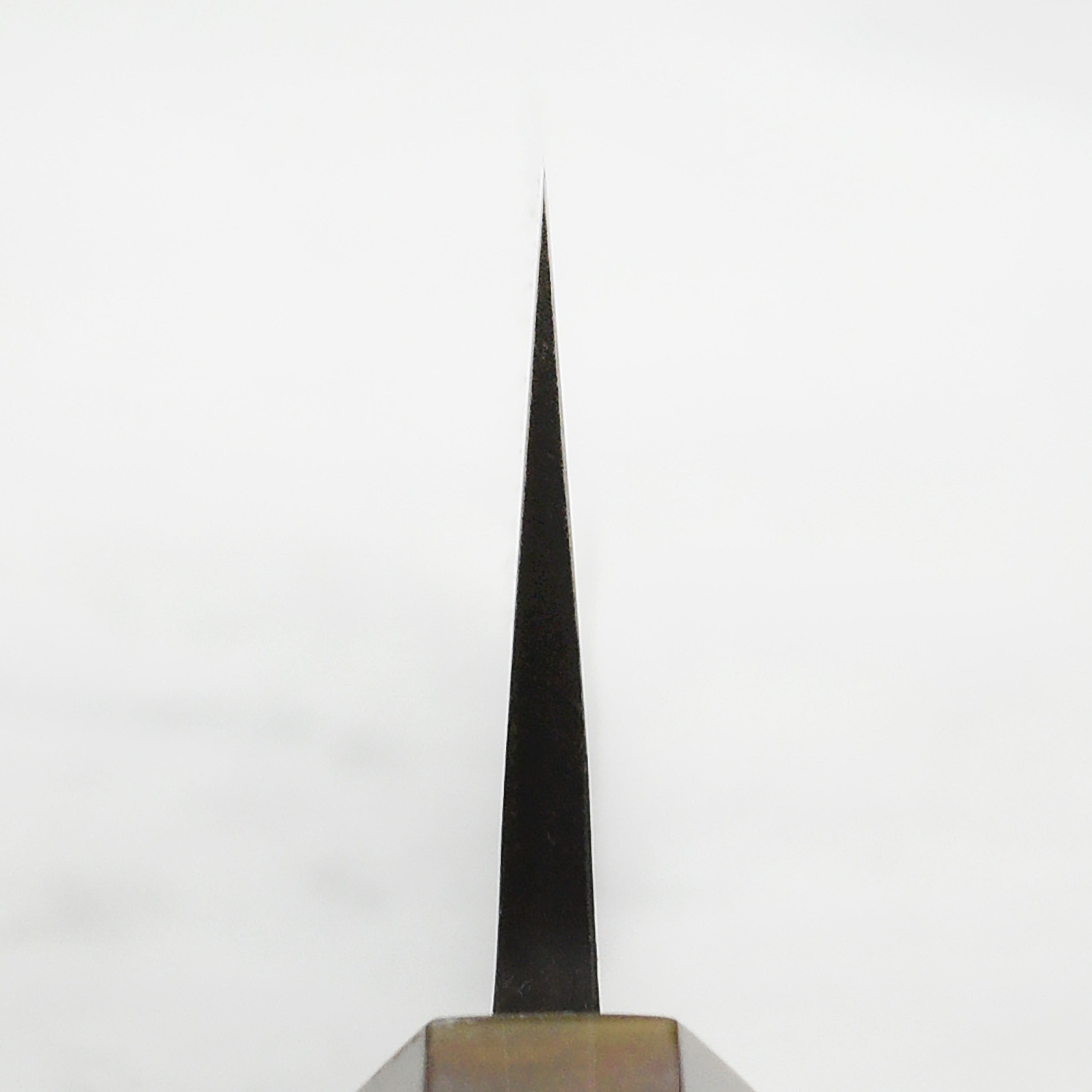 Side view of the Hatsukokoro Gyuto Knife displaying its ebony handle and craftsmanship.
