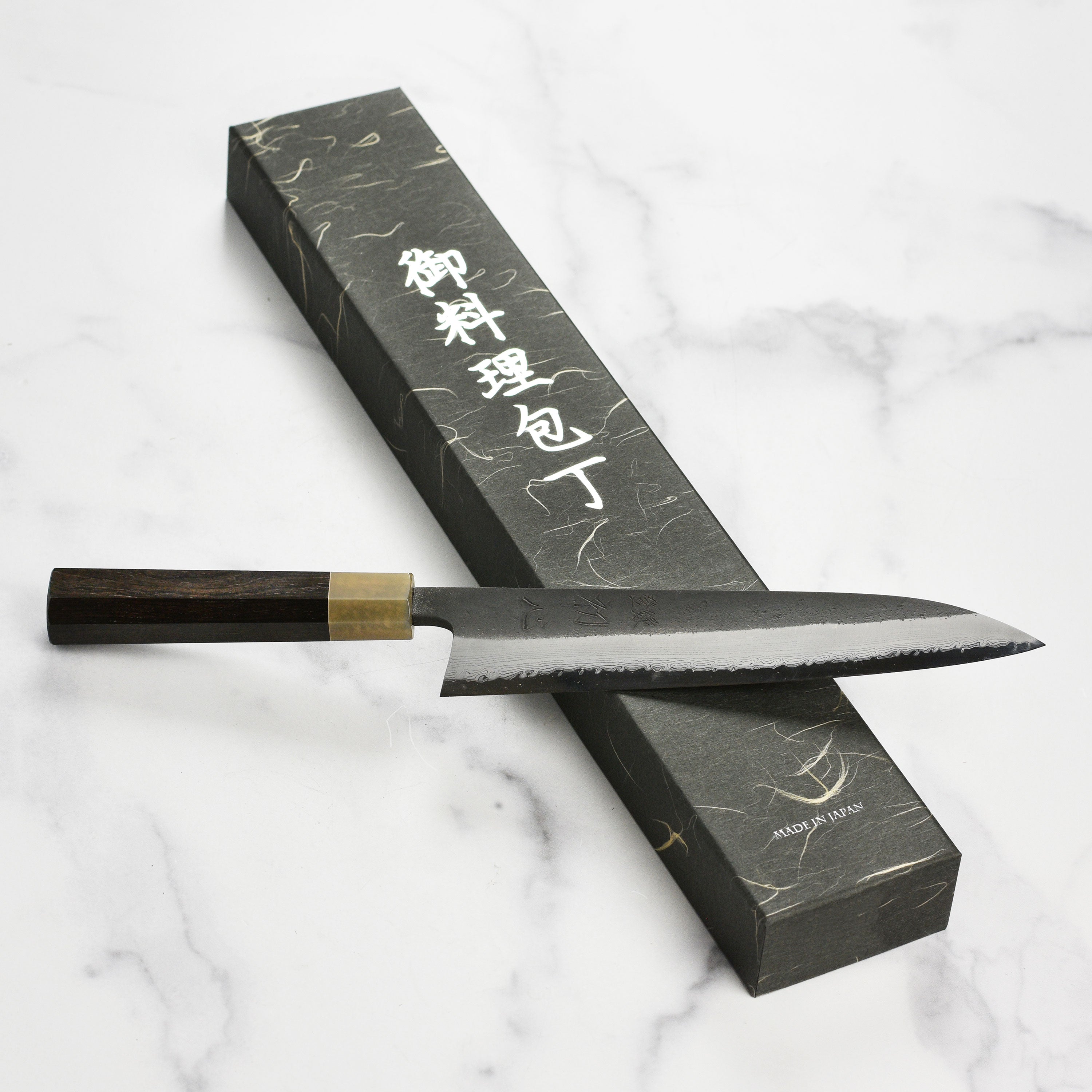 Close-up of the Hatsukokoro Shinkiro Gyuto Knife blade highlighting the Damascus pattern.