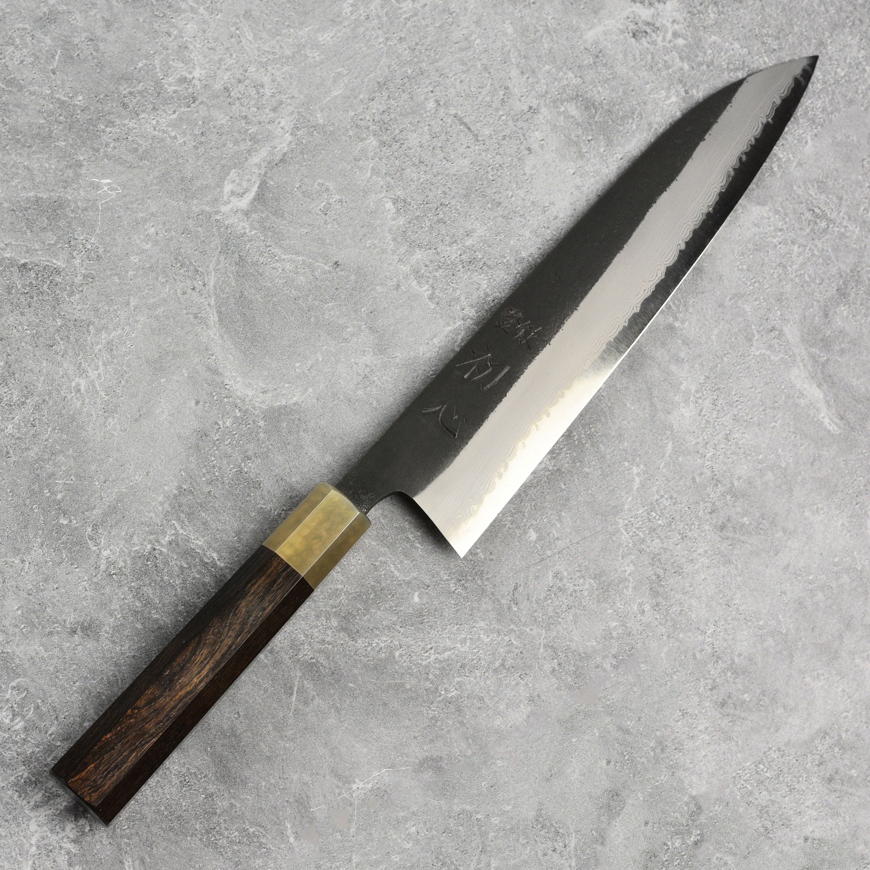 Close-up of the Hatsukokoro Shinkiro Gyuto Knife blade highlighting the Damascus pattern.