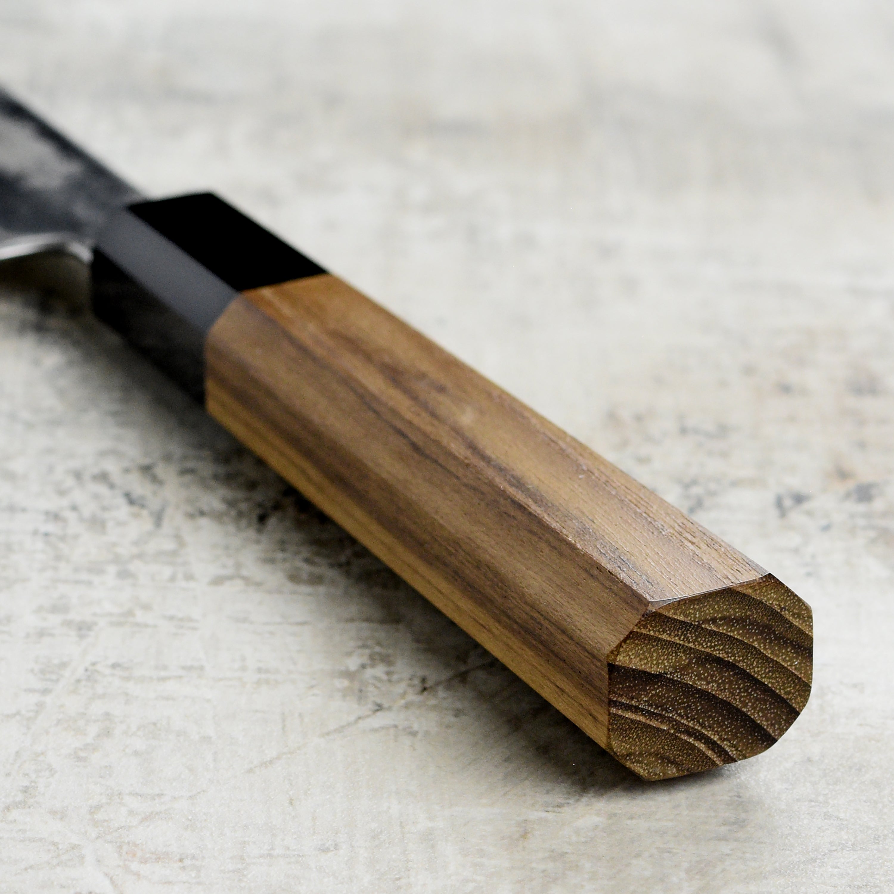 Hatsukokoro Ginsou Damascus Gyuto Chef Knife in action, slicing fresh vegetables on a cutting board.