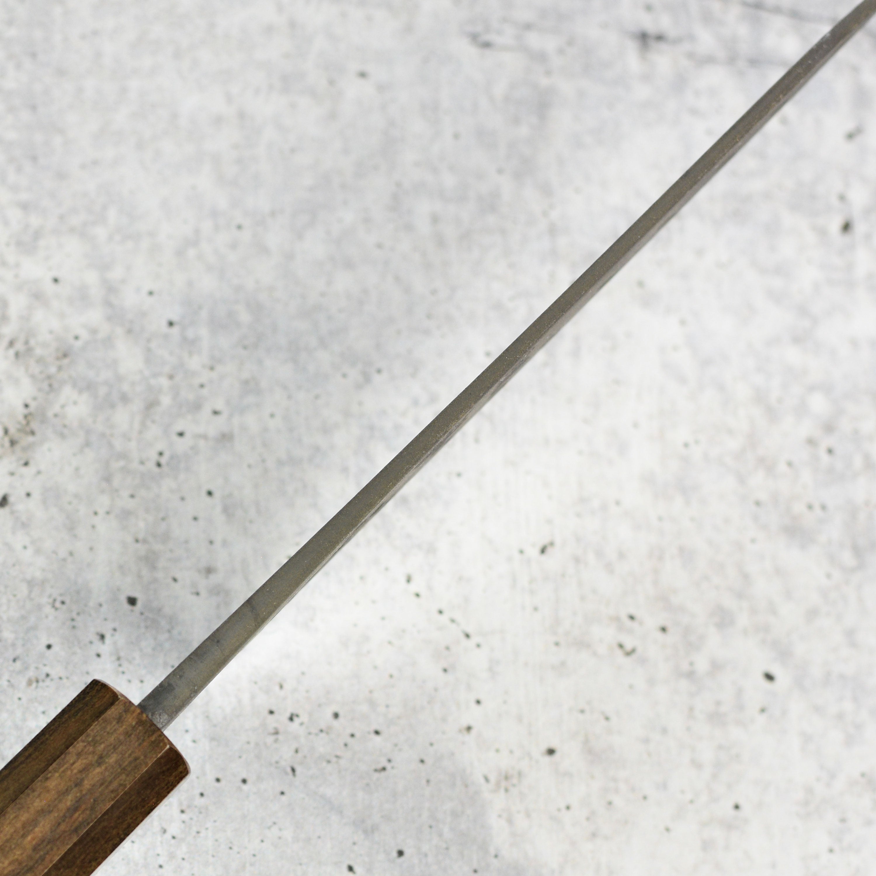 Bunka knife cutting vegetables with precision, showcasing its sharp edge and craftsmanship