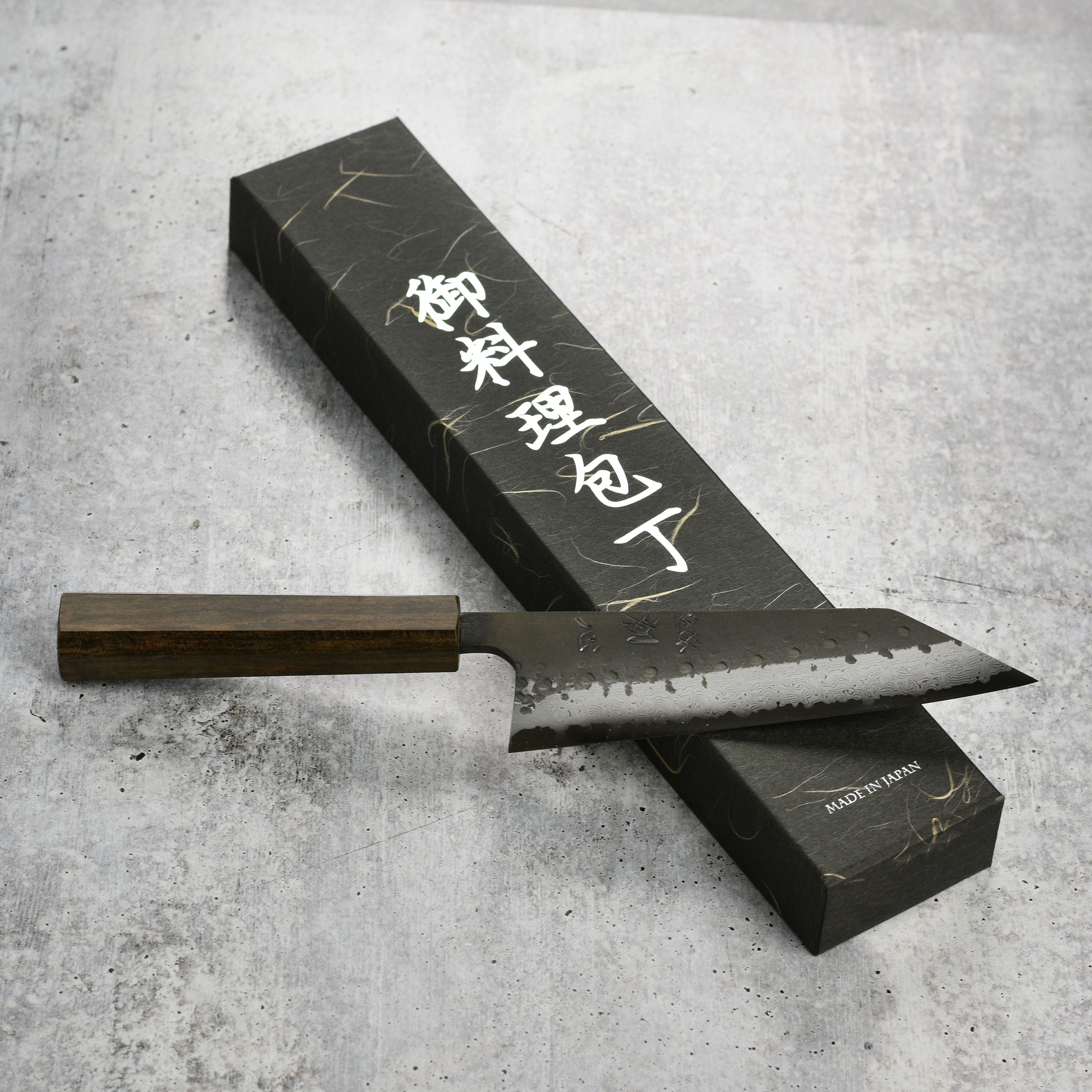 Detail shot of the high carbon steel blade and bubinga handle of the Japanese kitchen knife