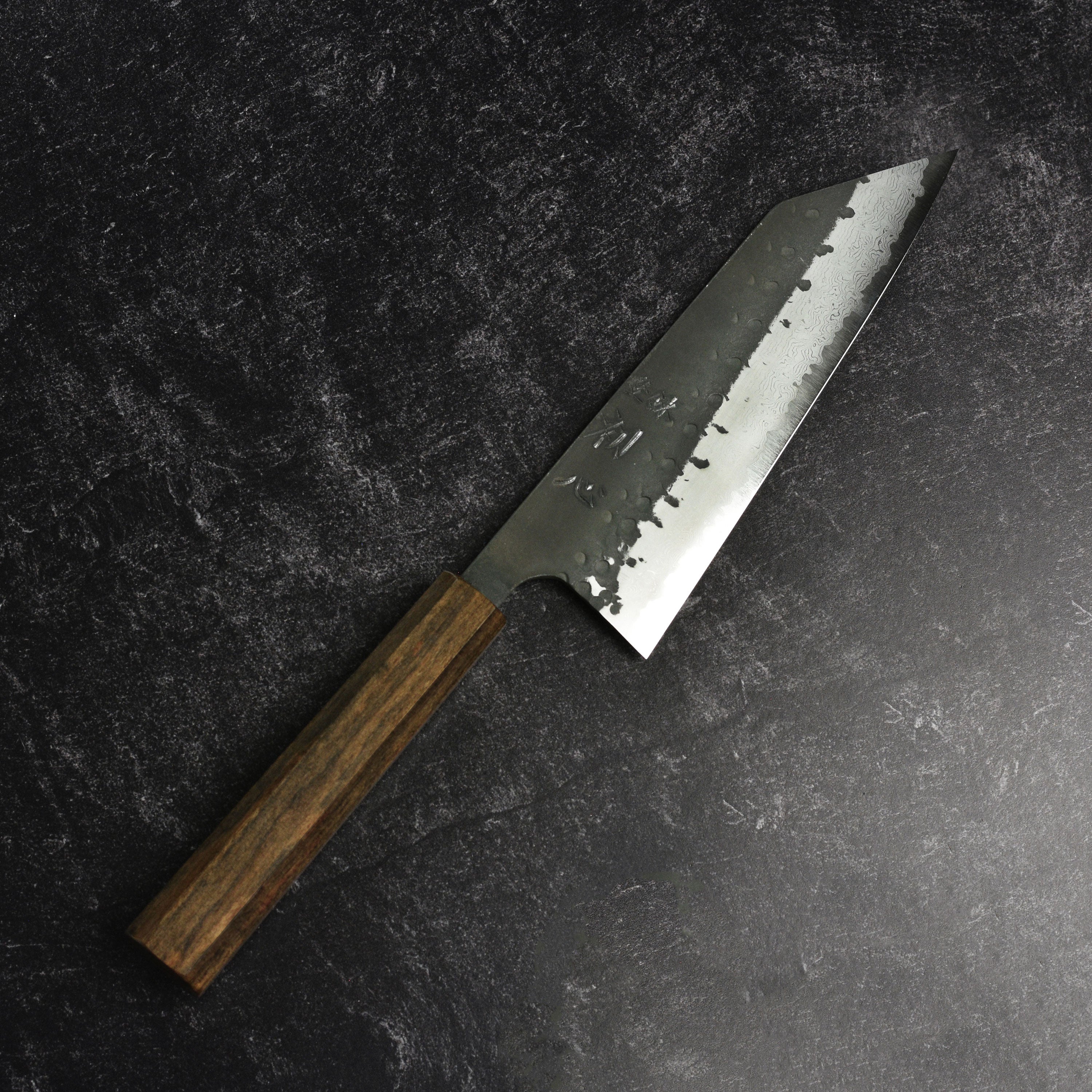Bunka knife cutting vegetables with precision, showcasing its sharp edge and craftsmanship