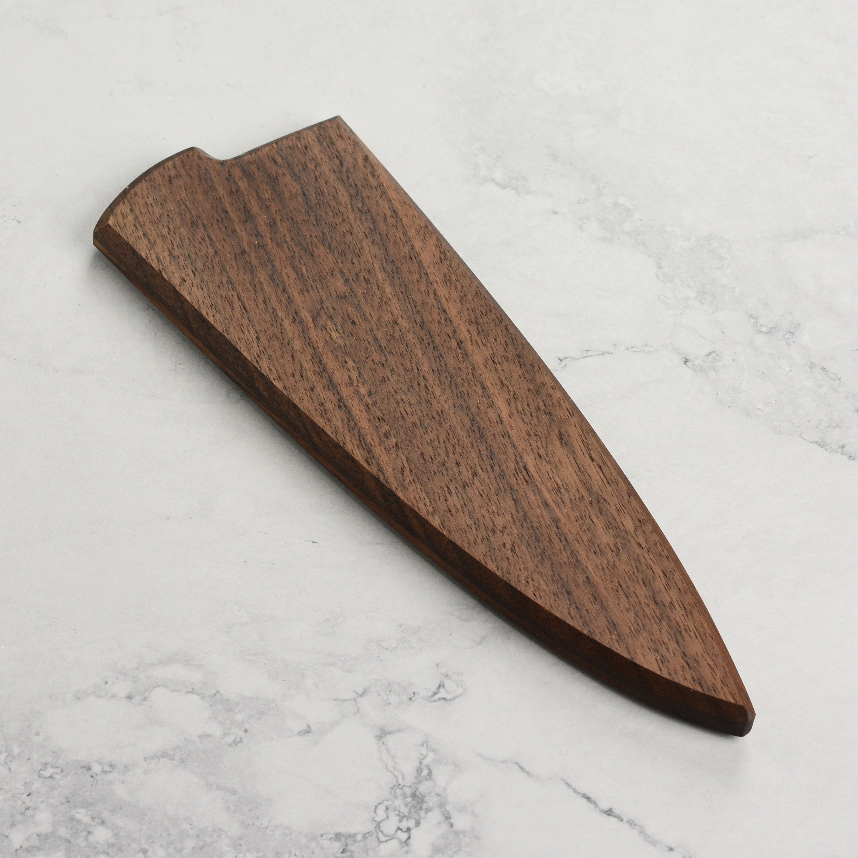 Close-up of magnetic saya securing an 8-inch Kramer chef knife in walnut finish