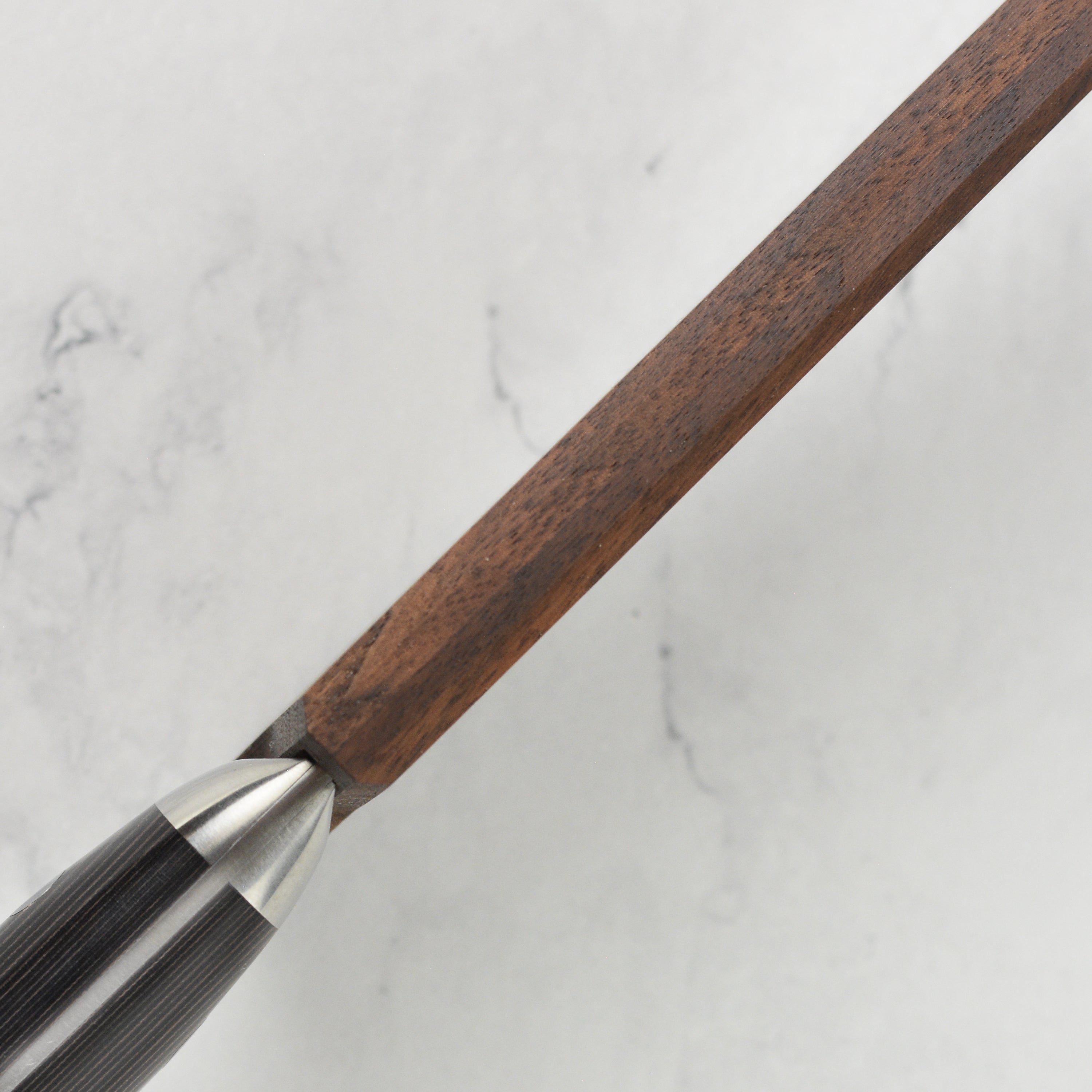 Chef knife cover resting on kitchen counter – sleek walnut design for safe storage