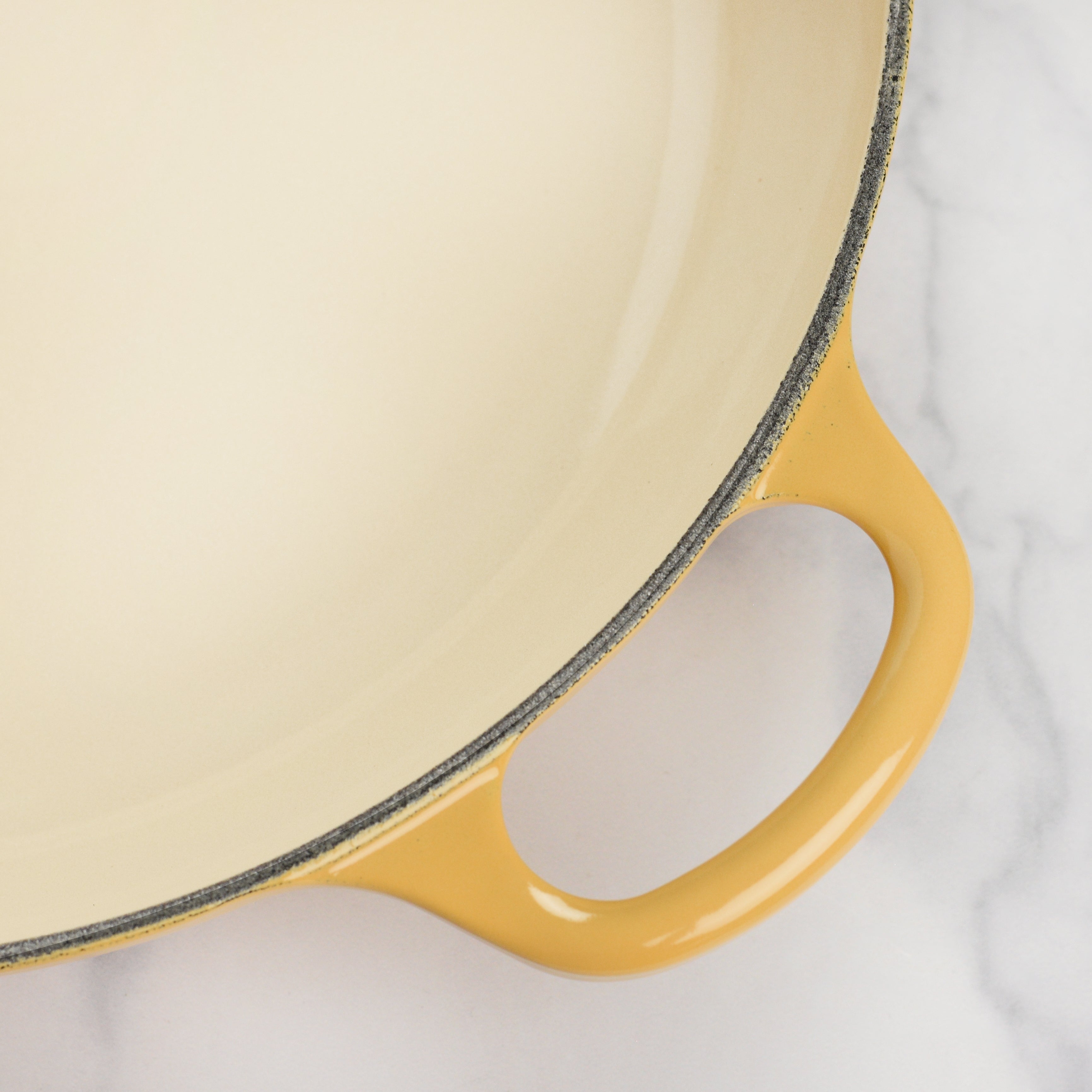 Close-up of the ergonomic knob and handles of the Le Creuset braiser