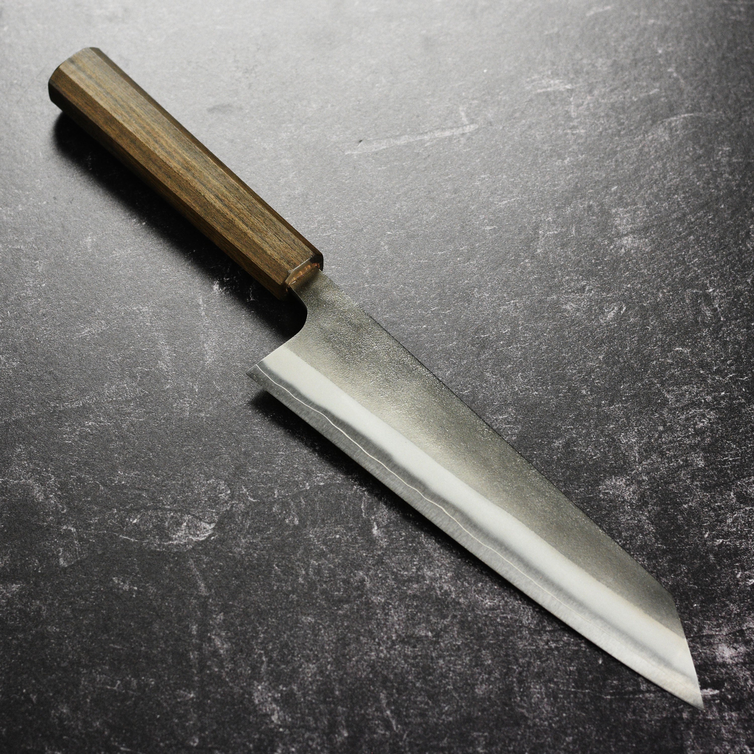 Yoshikane SKD Kiritsuke knife close-up highlighting the blade's finish.