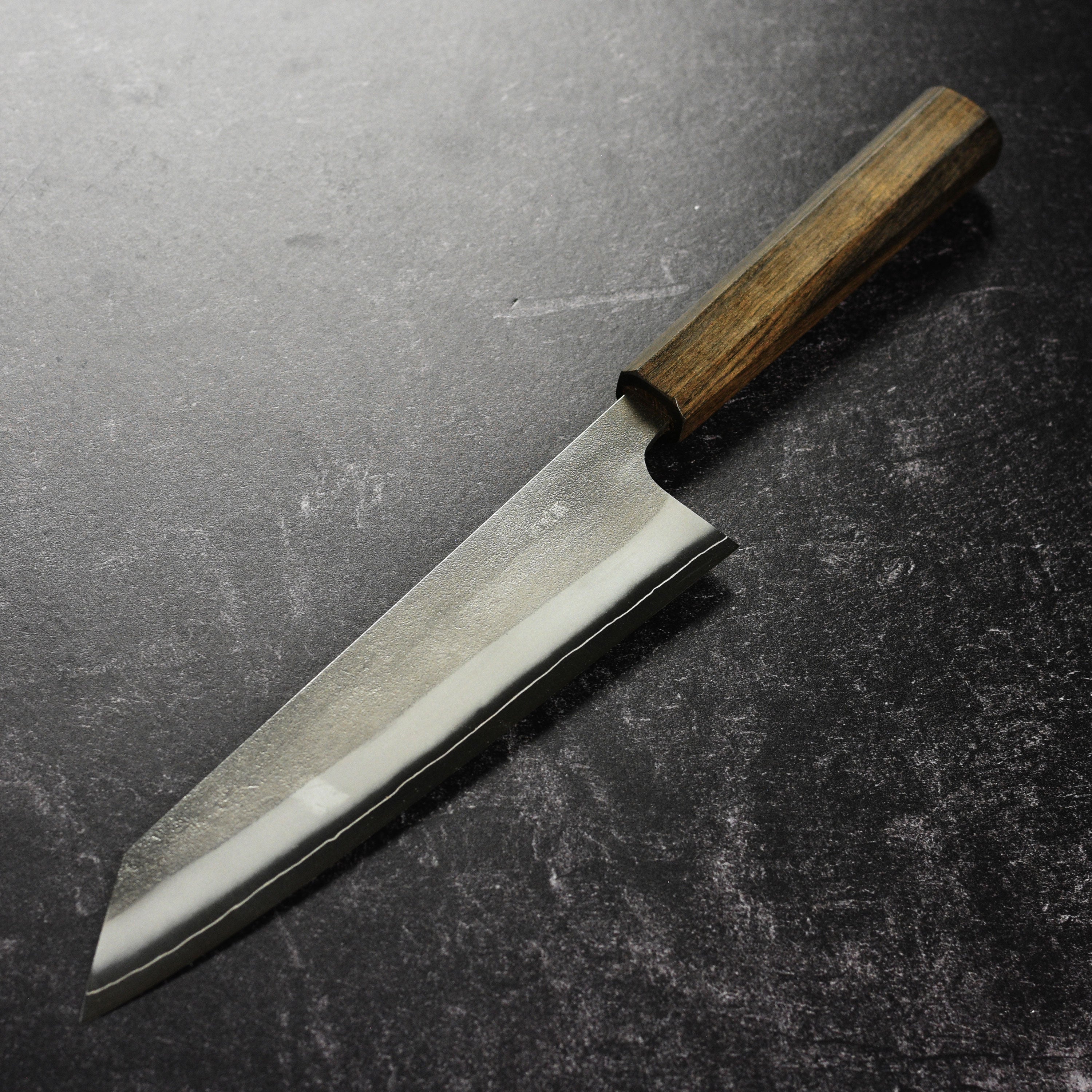 Chef using the Yoshikane Kiritsuke knife for slicing vegetables.