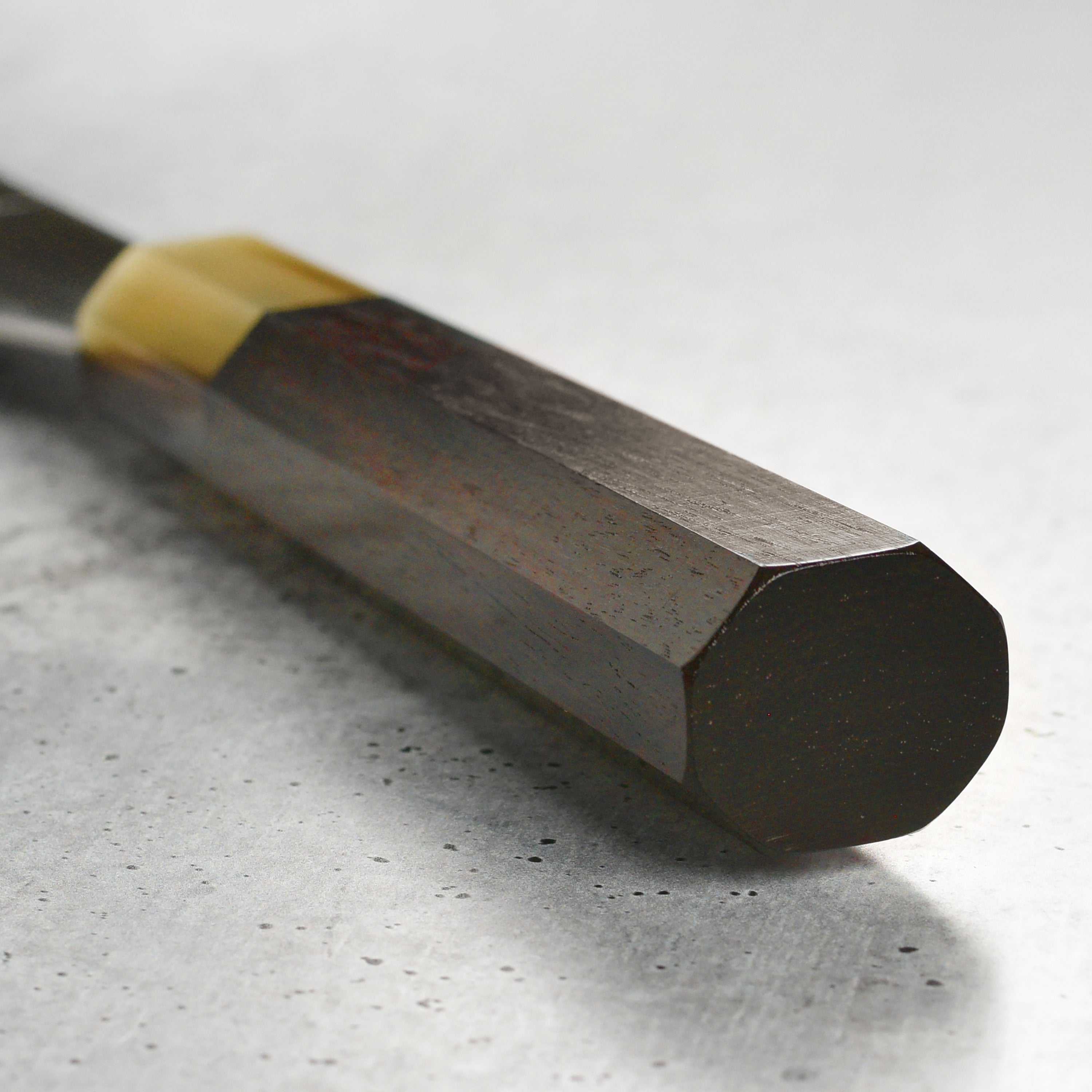 High carbon steel gyuto knife in hand, ready for precision cutting