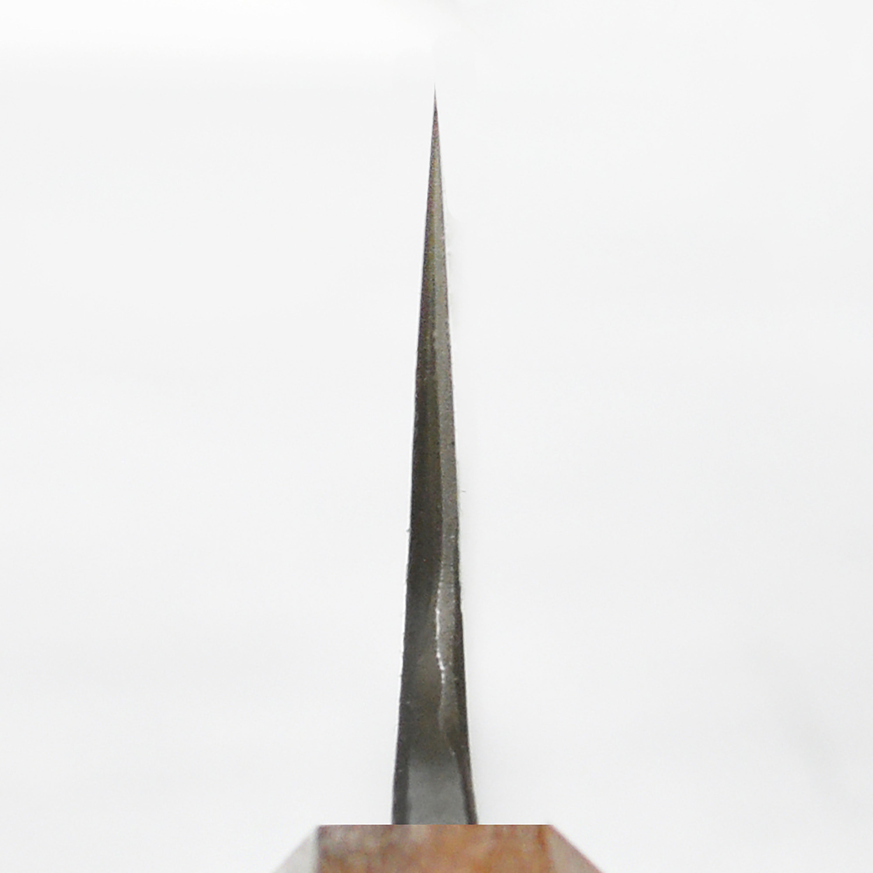 Side view of the Mazaki Shirogami Kurouchi Gyuto knife displaying its unique Kurouchi finish and ergonomic handle.