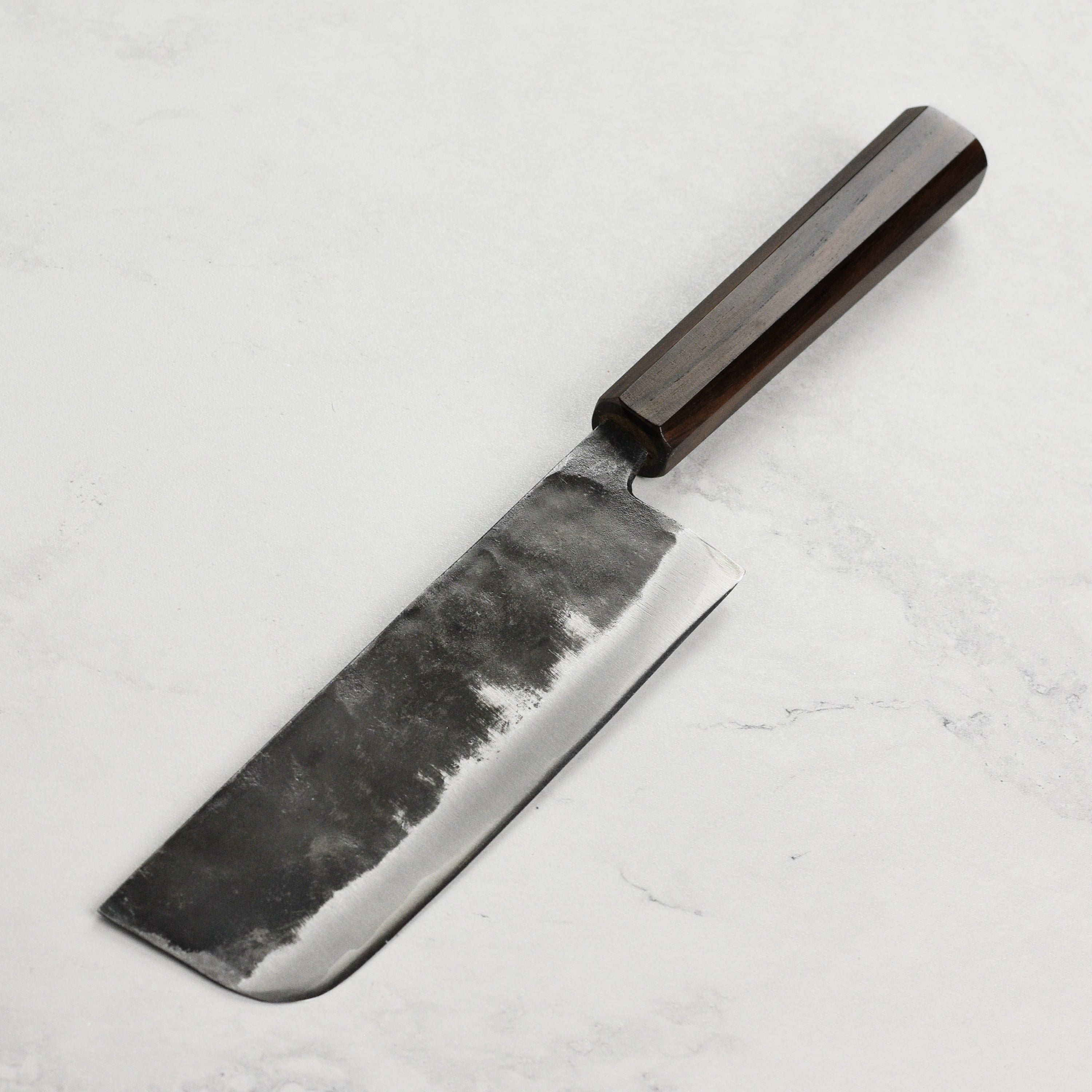 Detailed view of the blades craftsmanship and handle of the Nakiri knife.
