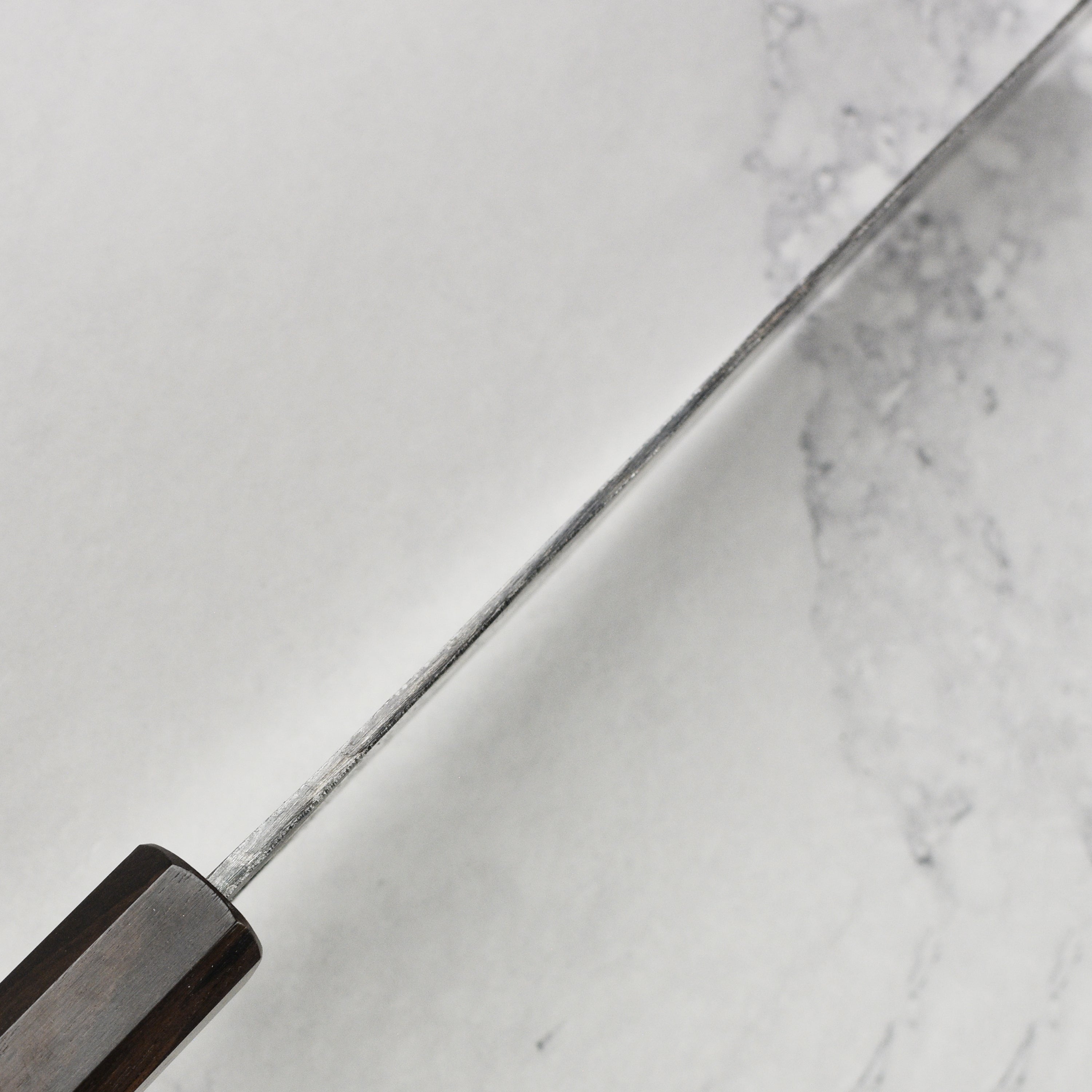 Detailed view of the blades craftsmanship and handle of the Nakiri knife.
