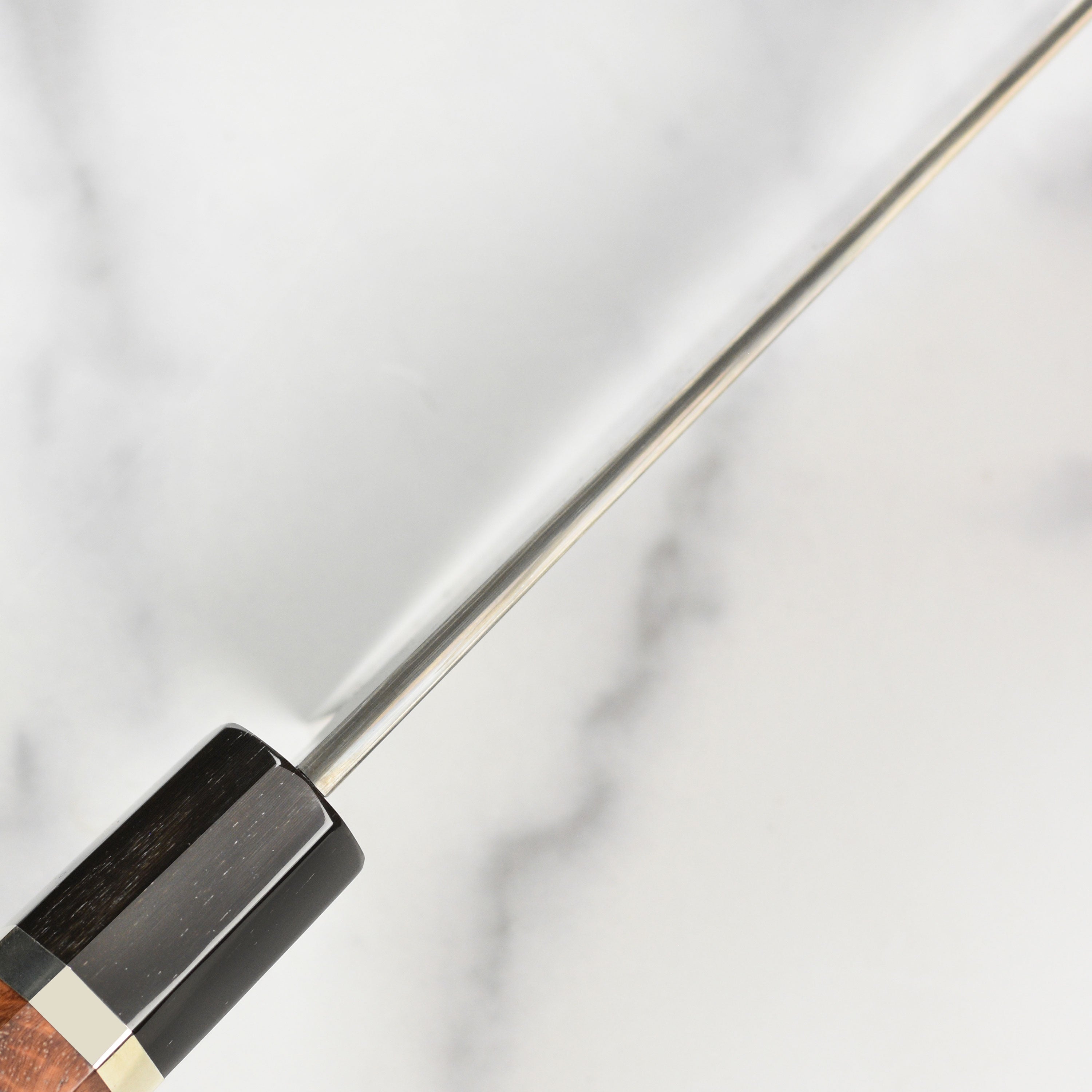 Handle and spine detail of the coreless Damascus Gyuto, highlighting craftsmanship and balance