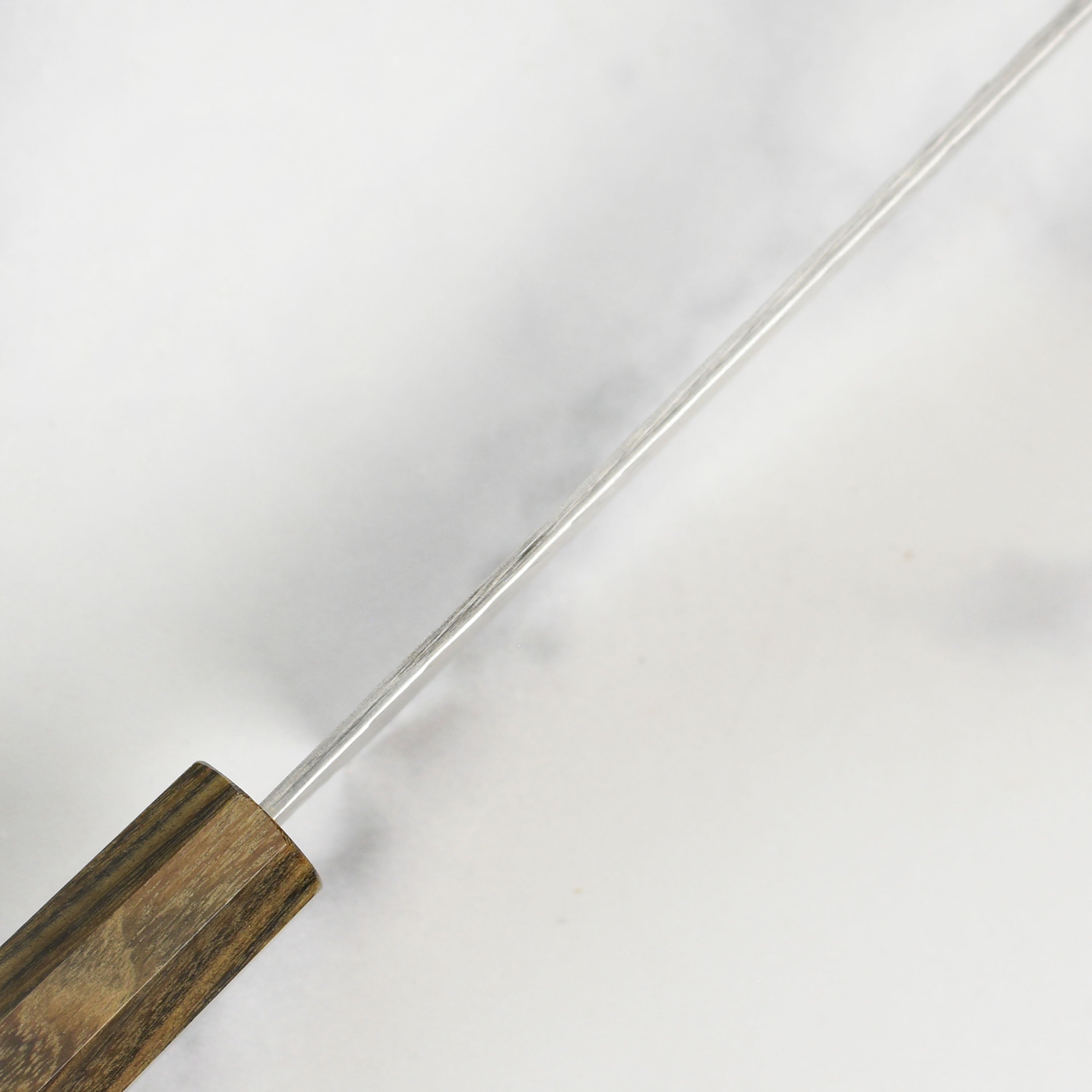 Complete view of the Nigara SG2 Migaki Tsuchime Kiritsuke Petty Knife on a wooden cutting board