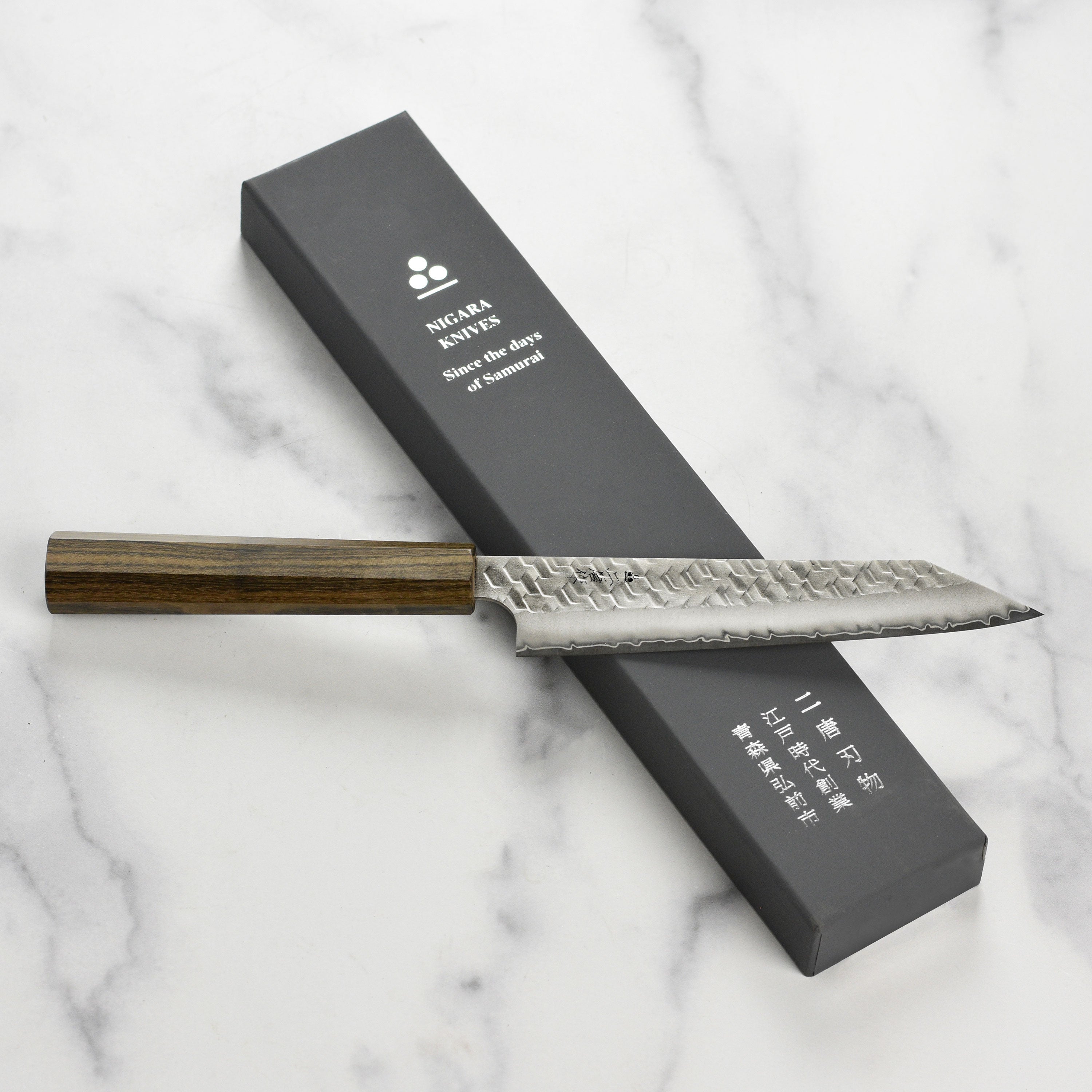 Chef using the Nigara Kiritsuke Petty knife for slicing vegetables in a professional kitchen