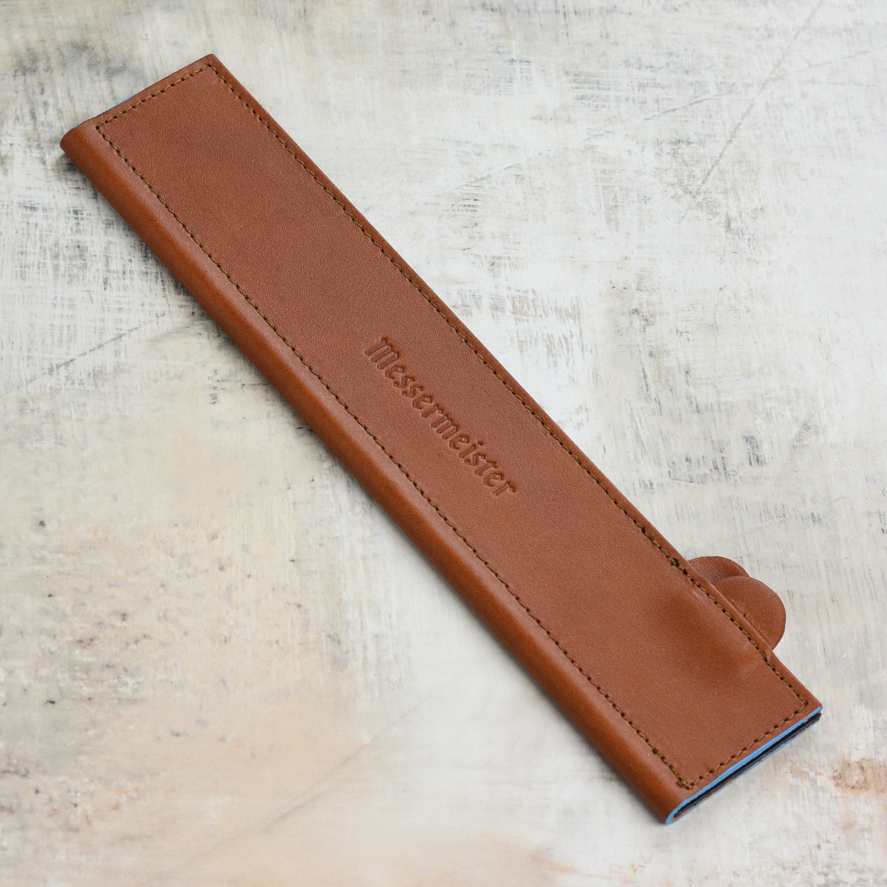 Close-up of leather edge-guard with magnetic seal for kitchen knives
