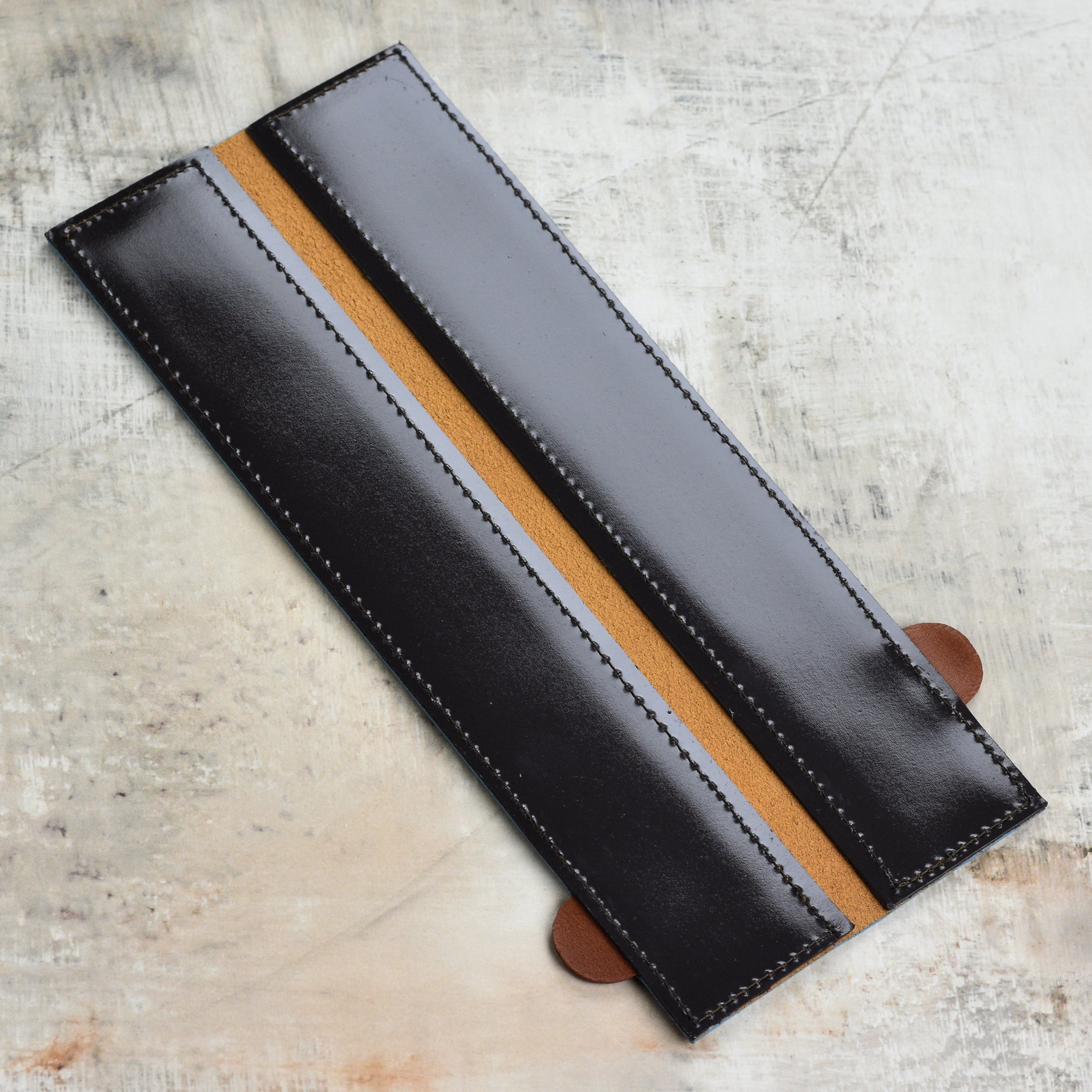 Close-up of leather edge-guard with magnetic seal for kitchen knives