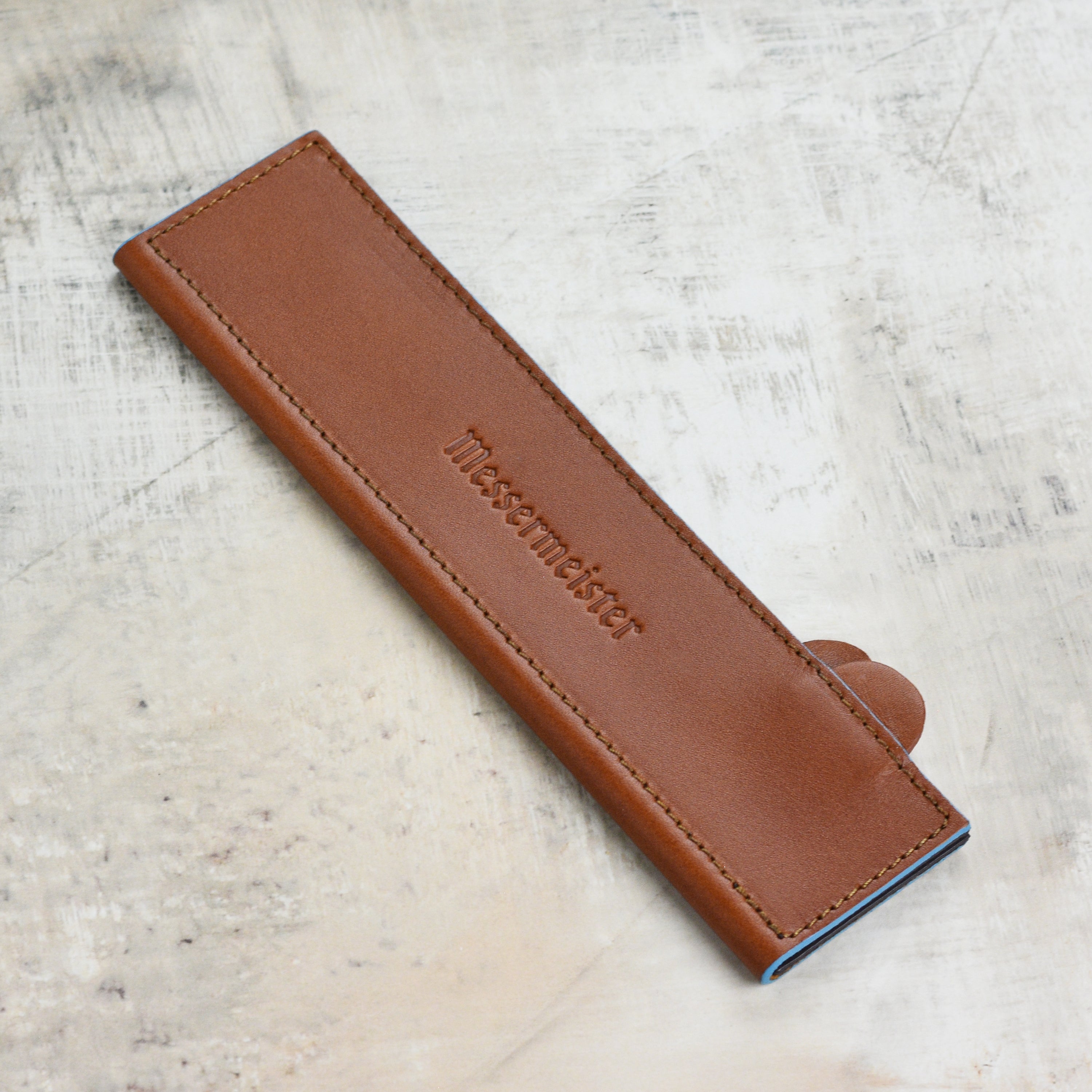 Close-up of the Messermeister 8.5-inch saddle magnetic knife sheath highlighting the rubber magnets for secure grip.