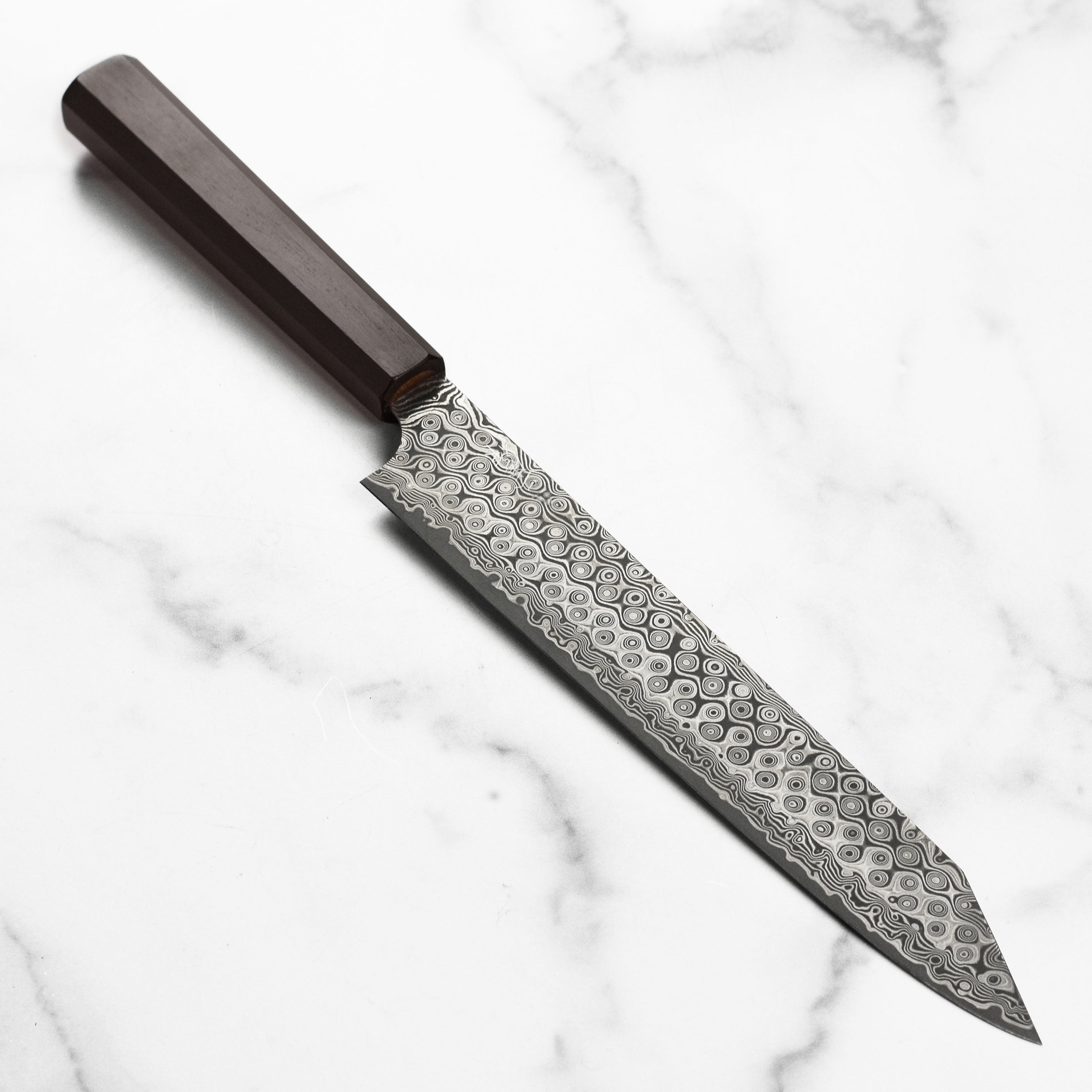 Close-up of Nigara SG2 Damascus Kiritsuke Sujihiki blade showing Damascus pattern