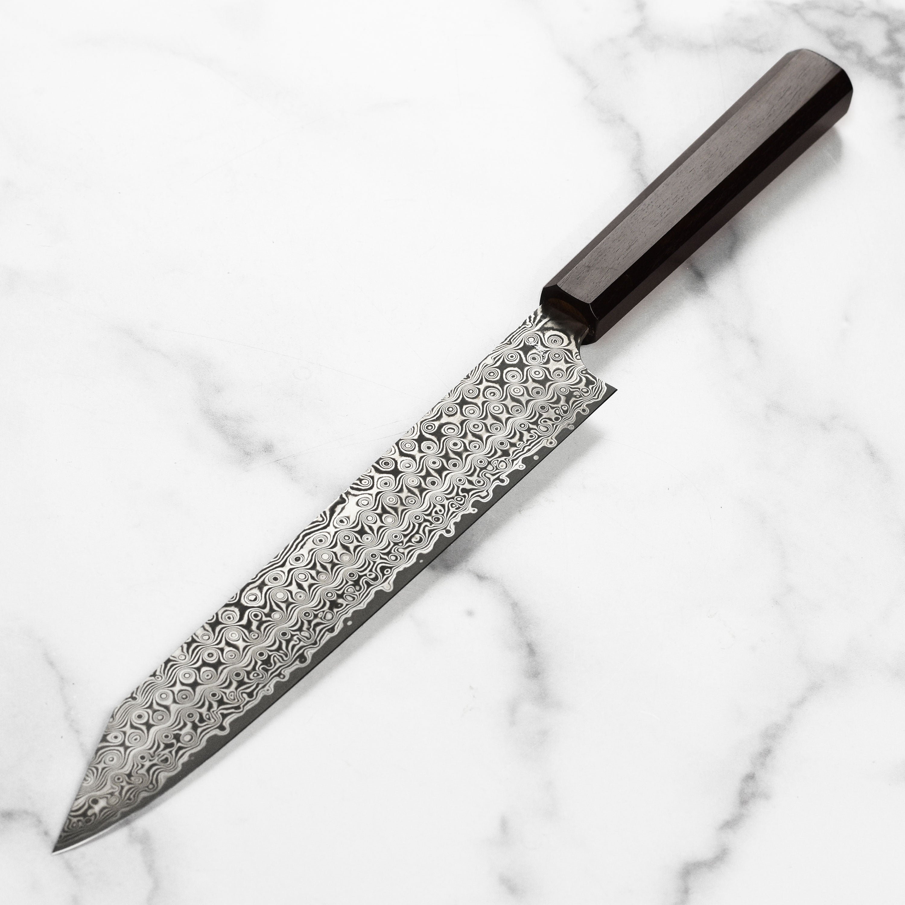 Chef slicing sashimi with the Nigara Kiritsuke knife in a professional kitchen