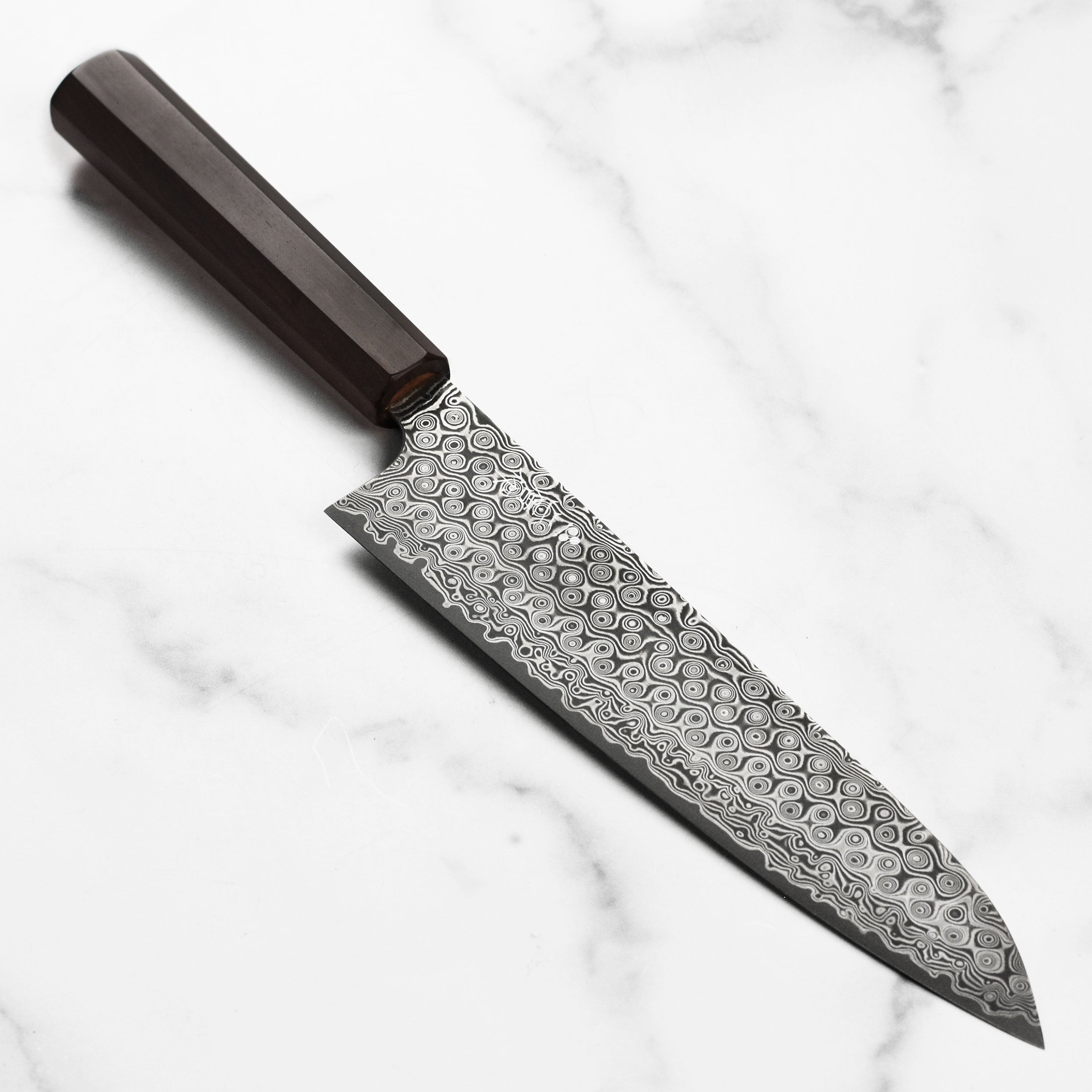 Close-up of Nigara Anmon SG2 Damascus Gyuto blade showing detailed damascus pattern