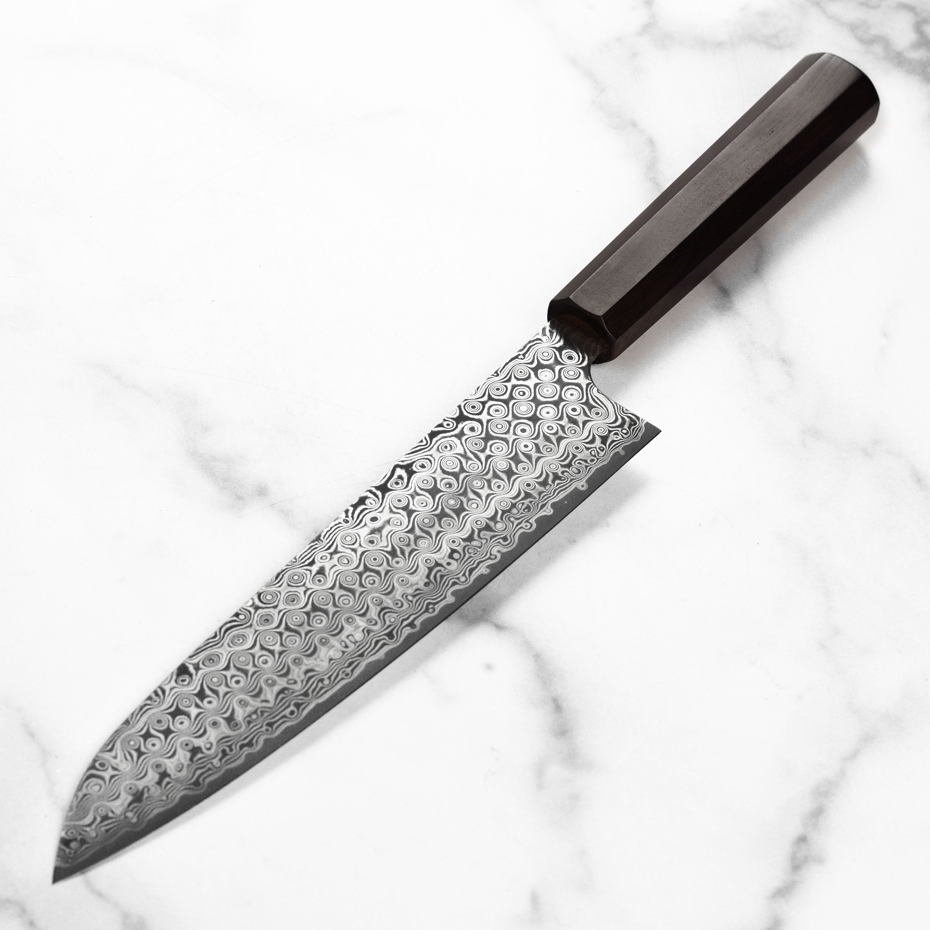Chef slicing vegetables with the 9.4-inch gyuto knife in a professional kitchen