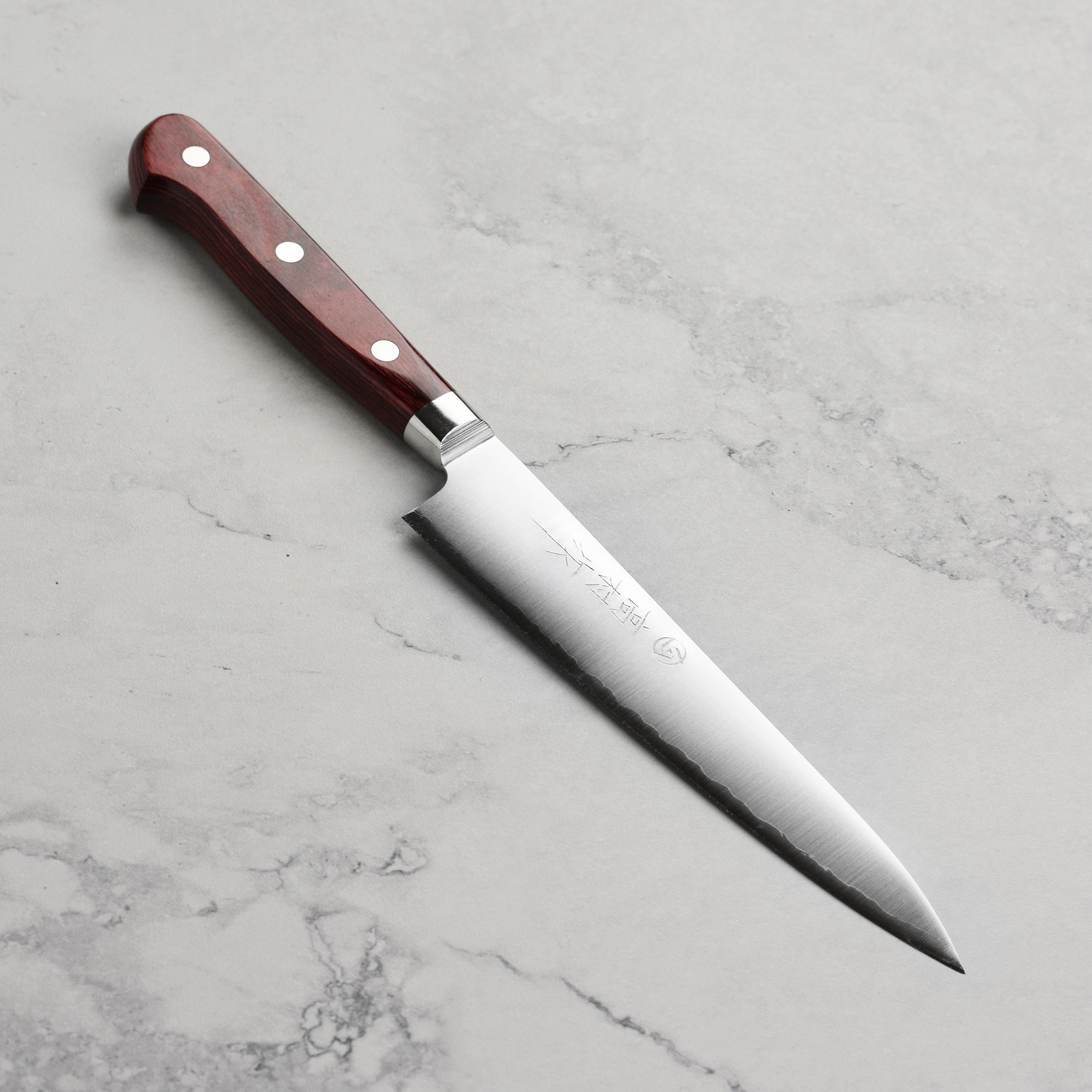 Takamura SG2 petty knife showcasing its sharp blade and ergonomic handle.