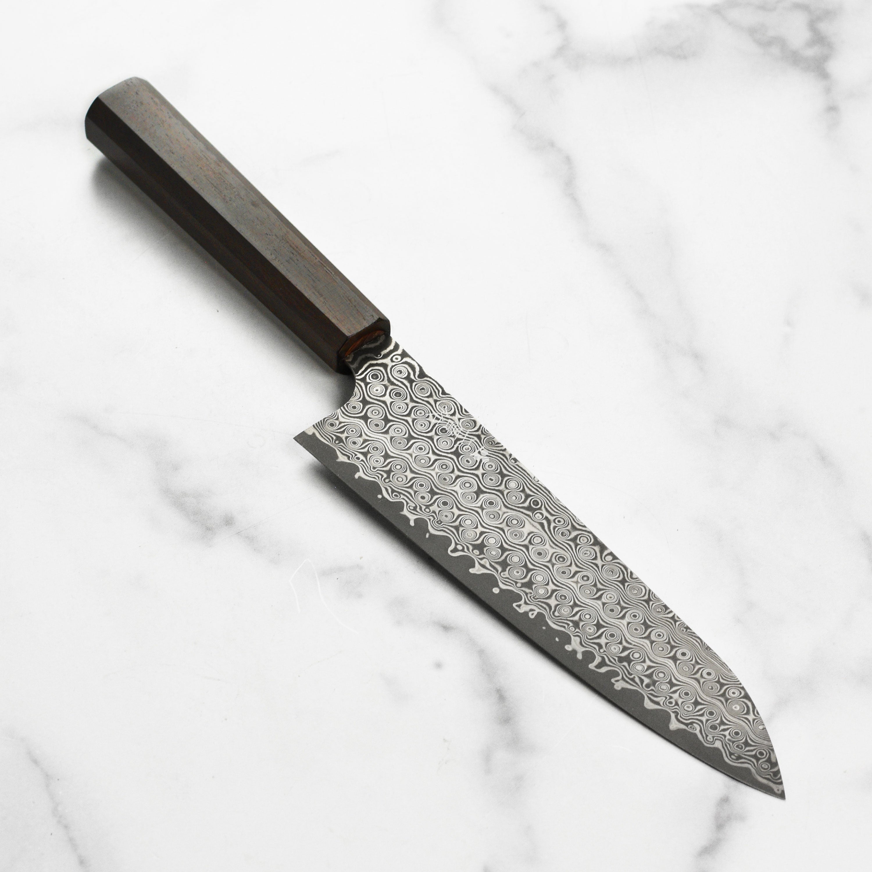 Front view of Nigara Anmon SG2 Damascus gyuto knife with detailed blade pattern