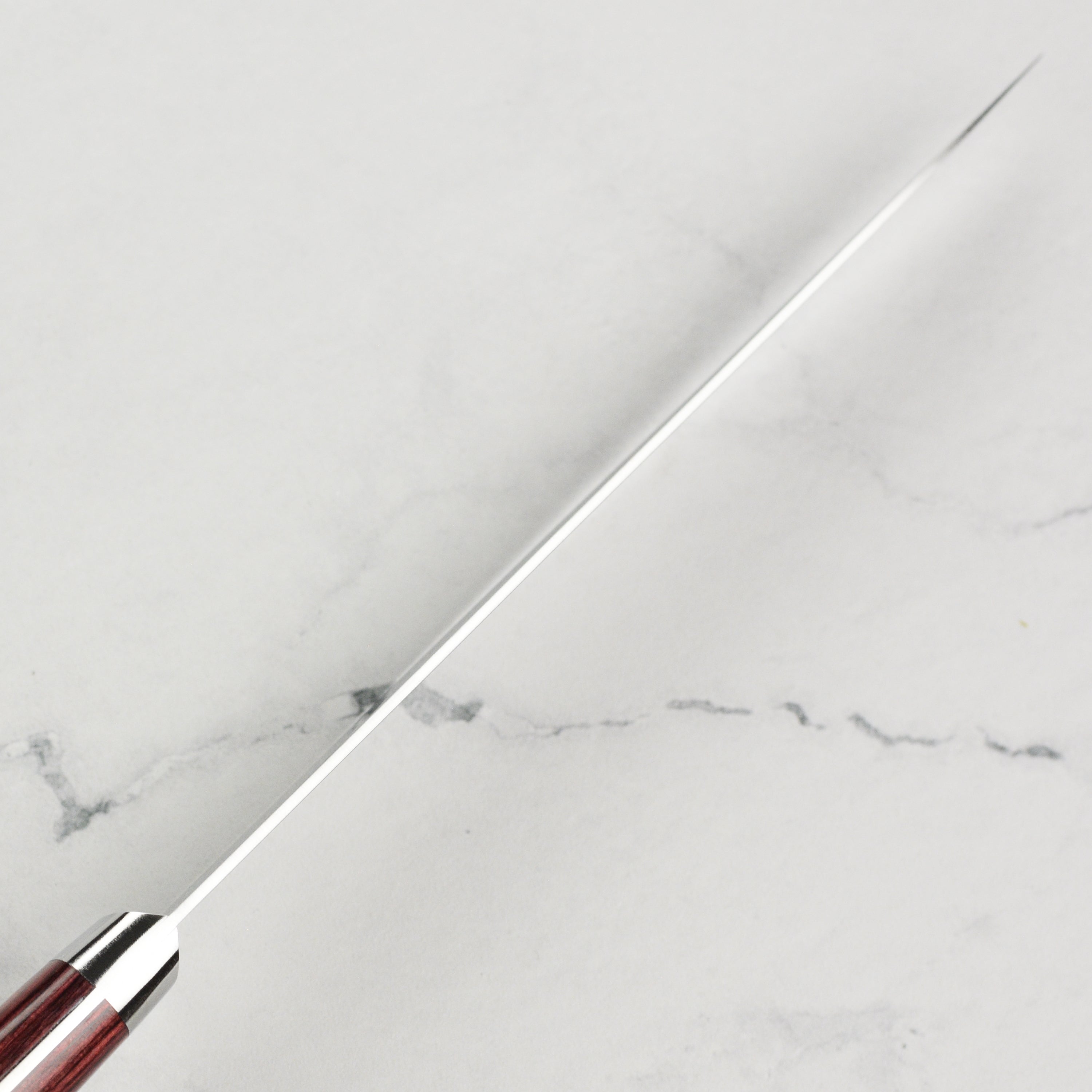 Takamura SG2 petty knife displayed on a wooden cutting board, highlighting its craftsmanship.