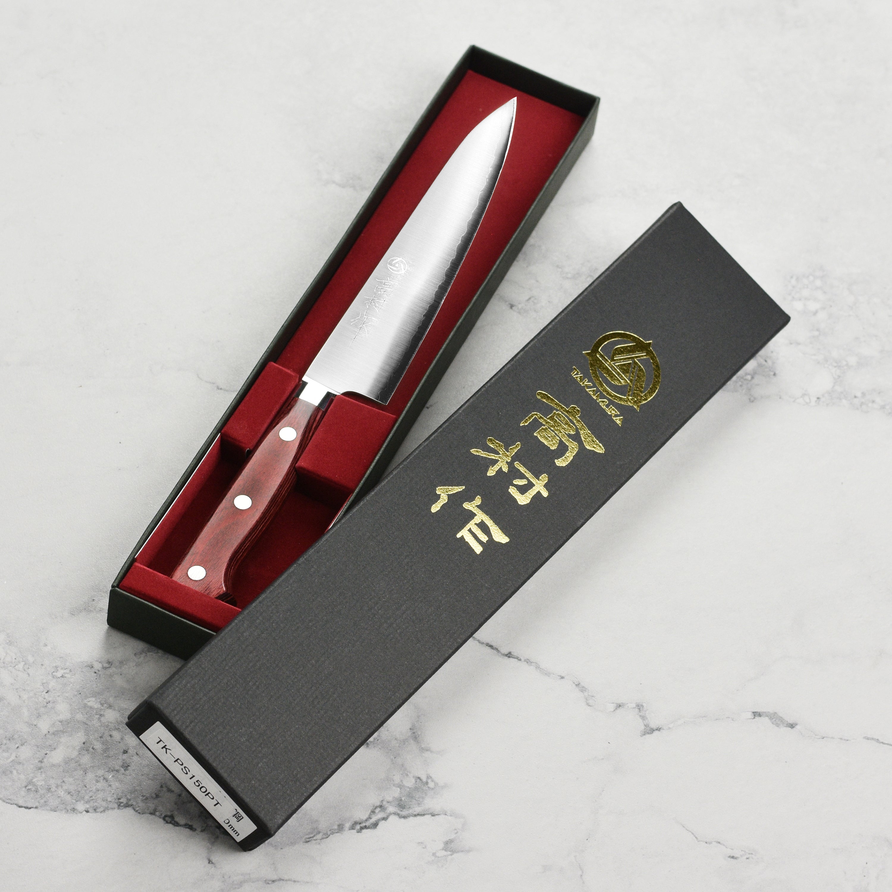 Takamura SG2 petty knife displayed on a wooden cutting board, highlighting its craftsmanship.