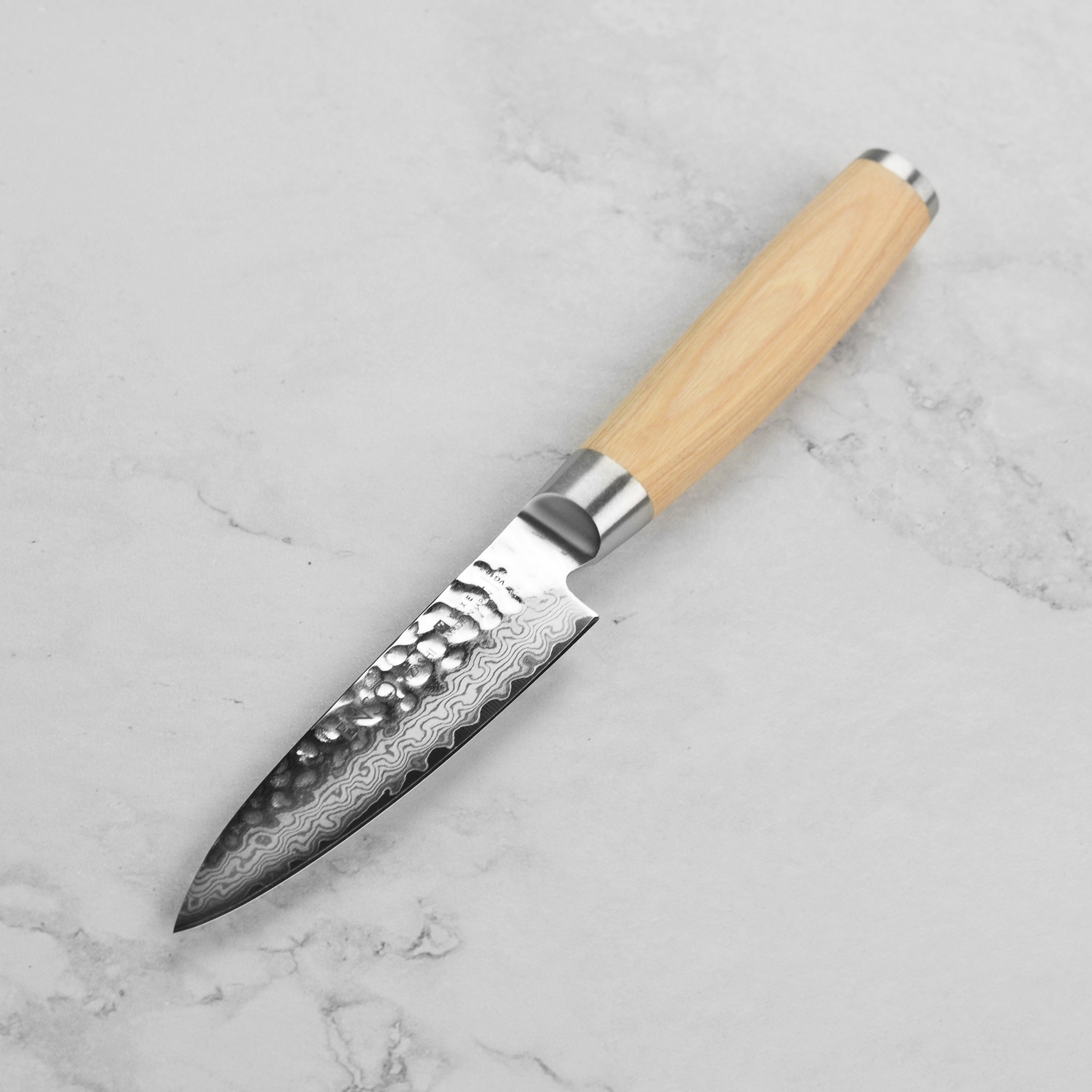 Close-up of the hammered finish on the Enso Damascus paring knife, highlighting its craftsmanship.