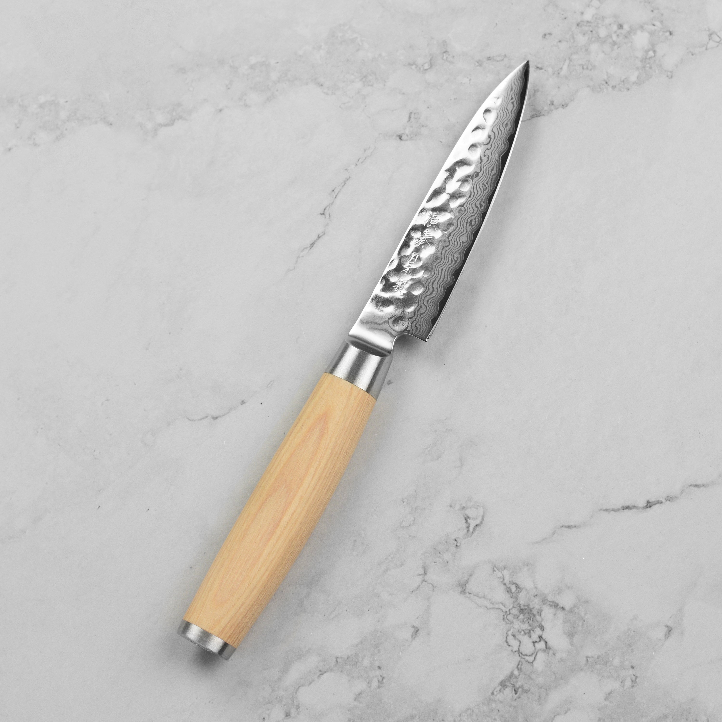 Enso Damascus 4" paring knife showcasing its 37-layer stainless steel blade and Pakkawood handle.