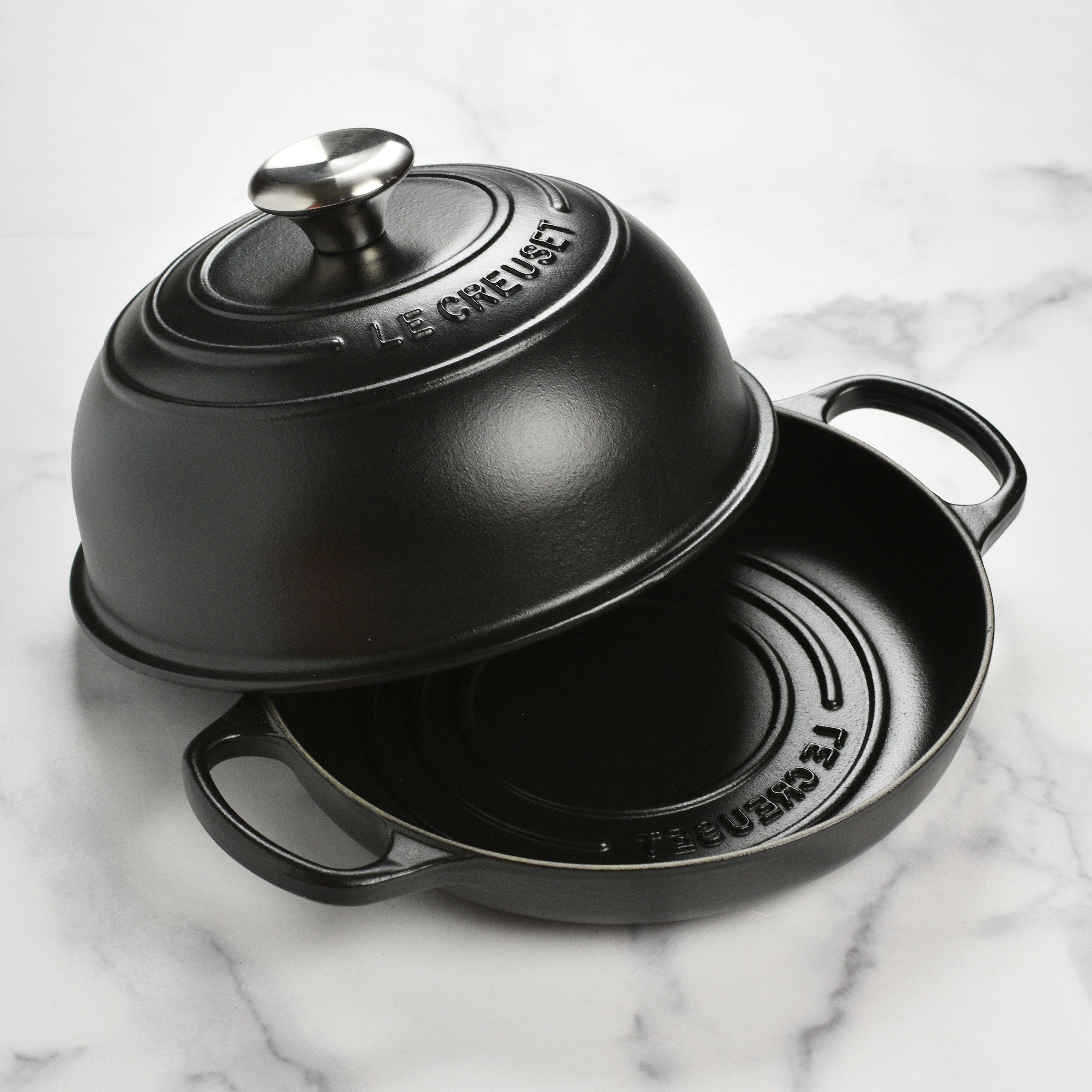 Close-up of Le Creuset cast iron bread oven with lid on, highlighting its enamel coating and ergonomic handles
