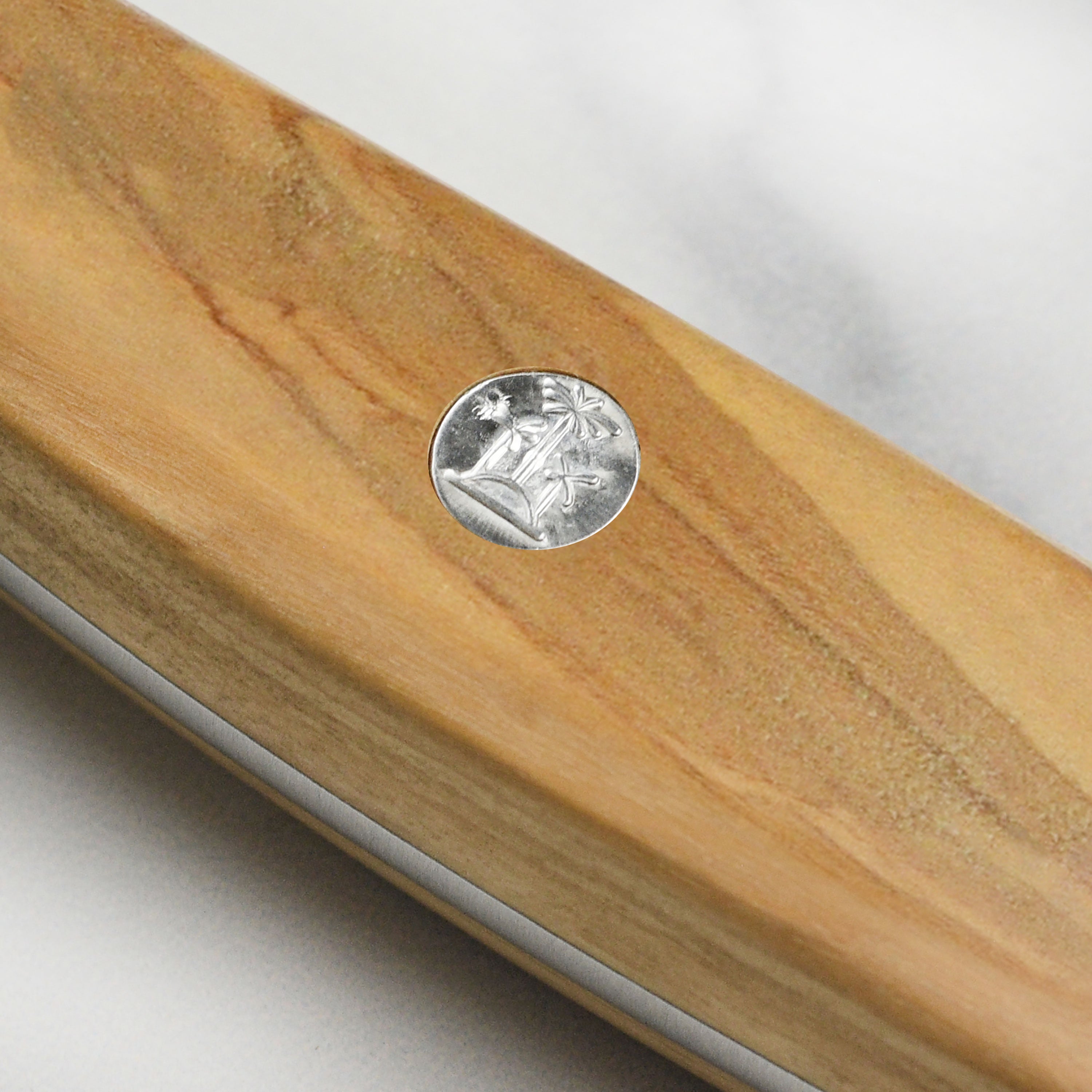 Using the Gude Alpha Olive Chai Dao for slicing vegetables in a modern kitchen