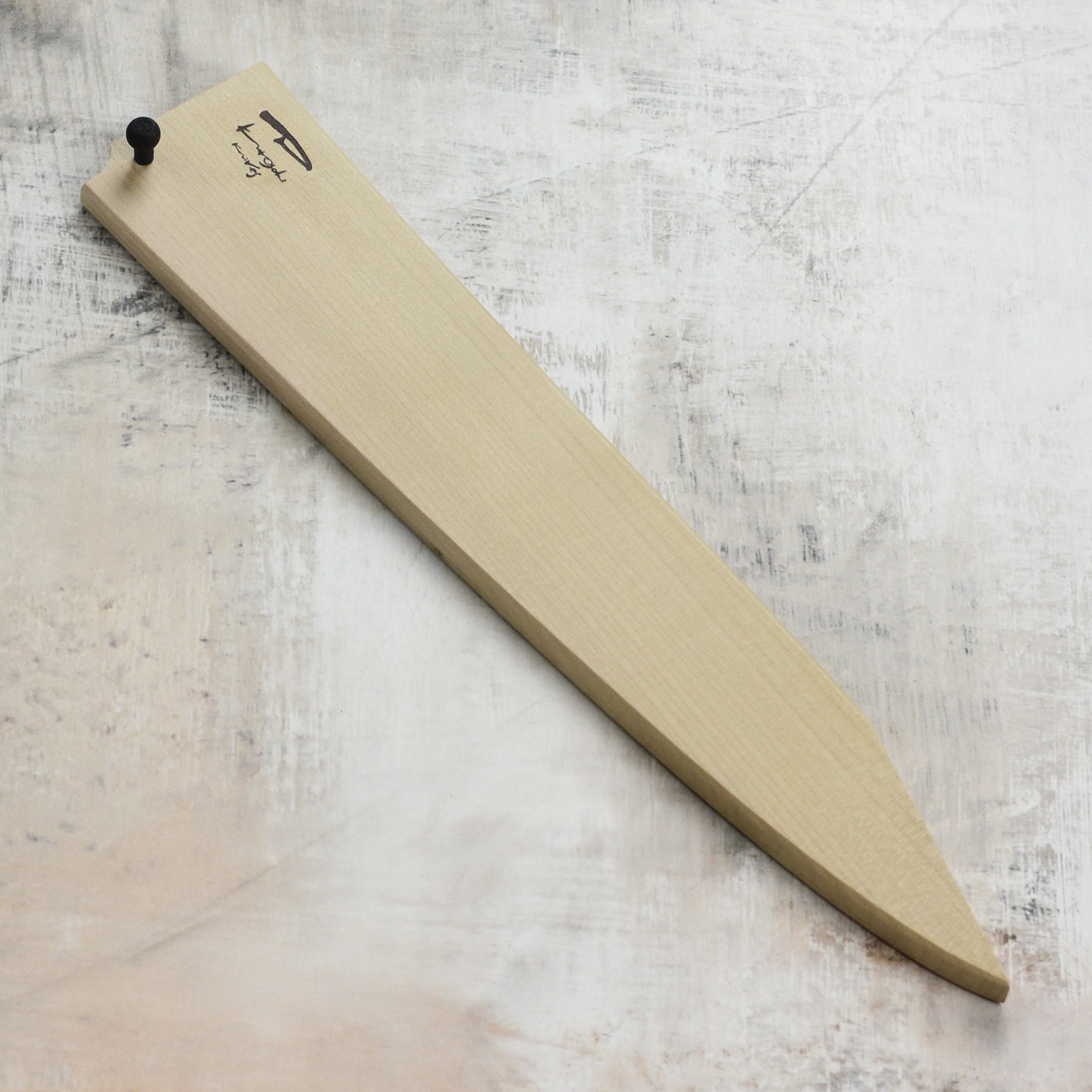 Kurosaki Saya 9.4-inch Sujihiki sheath covering a Japanese kitchen knife