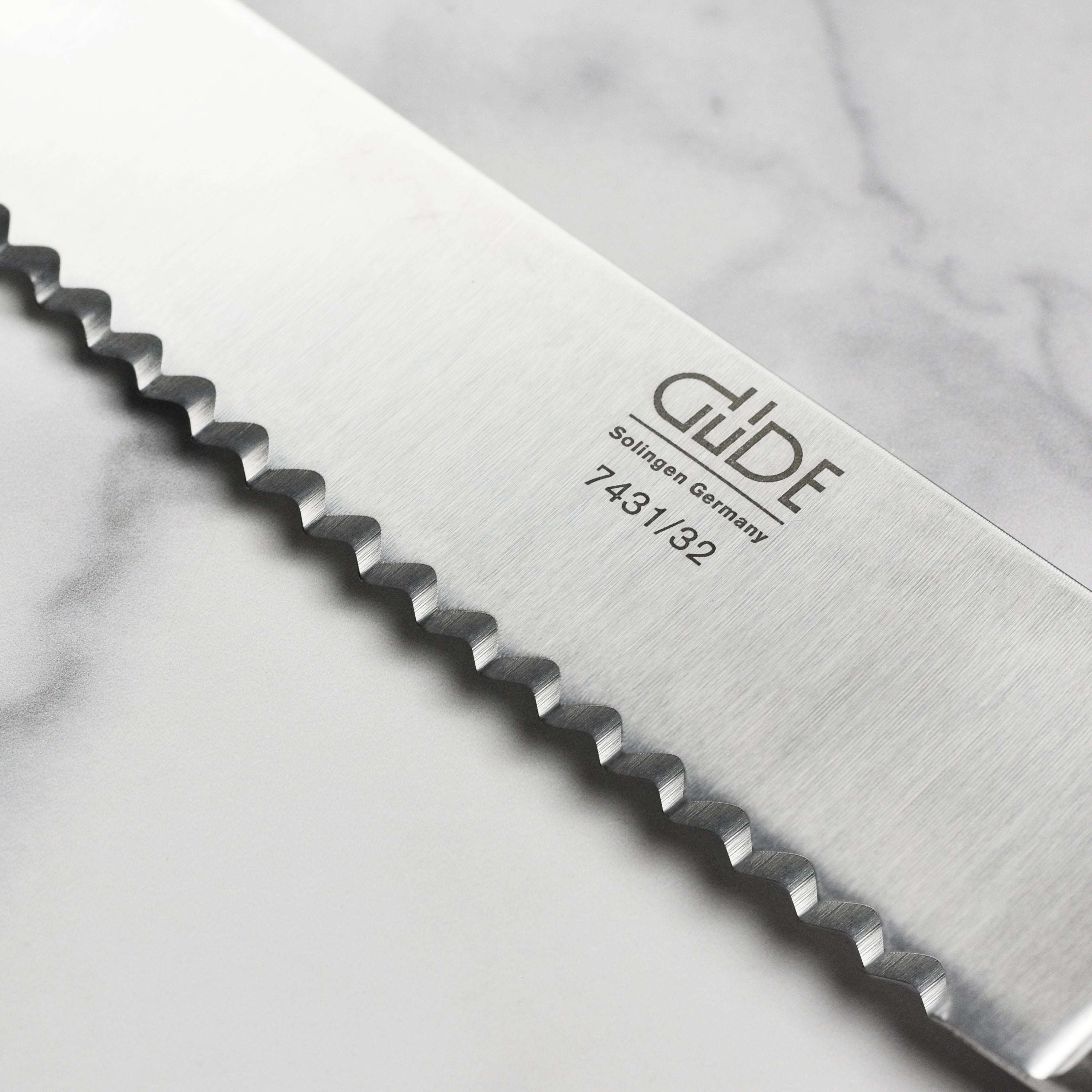 Elegant olive wood handle on the Franz Gude bread knife, handcrafted in Germany