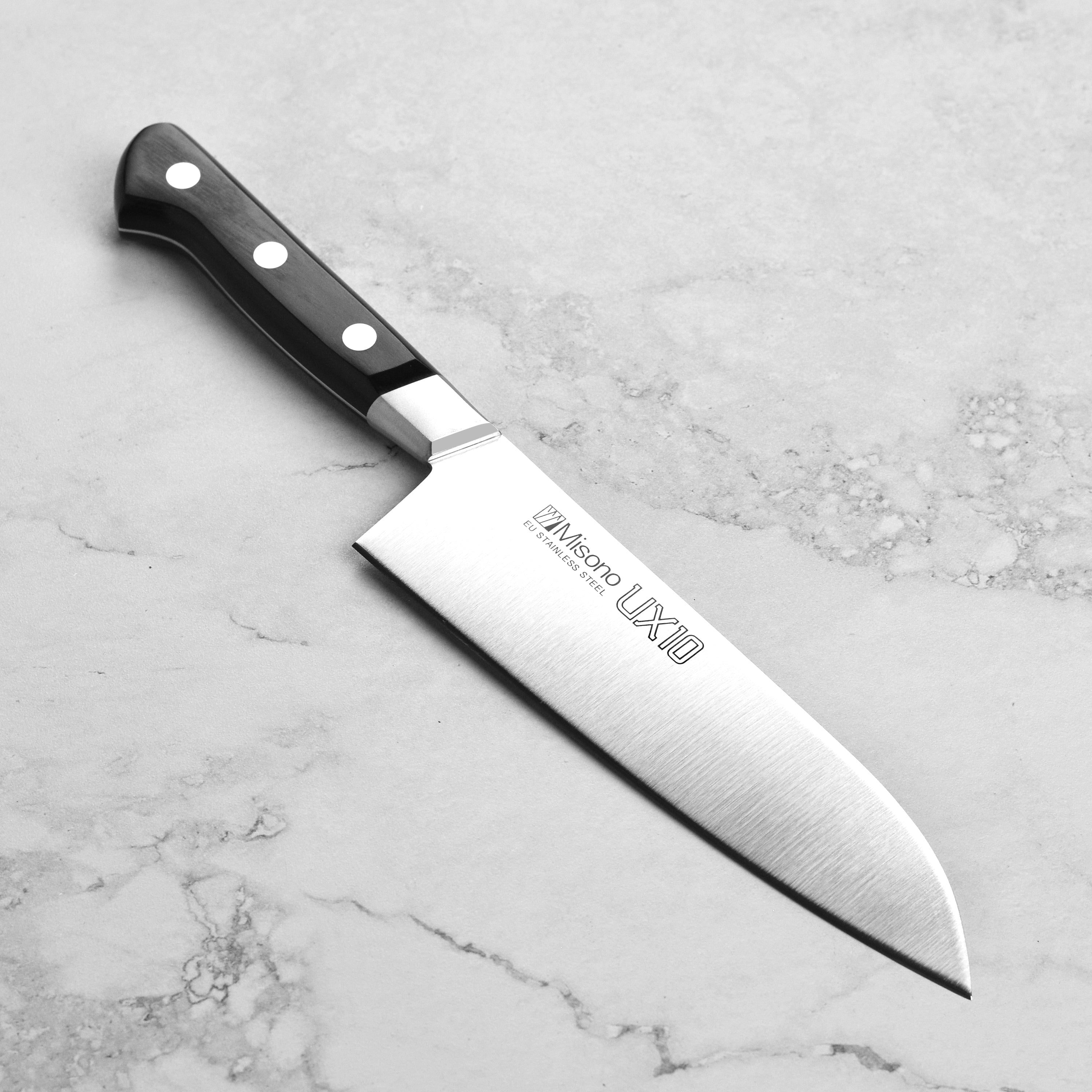 Misono UX10 Santoku knife showing the hand-forged blade and laminated black wood handle from a side angle.