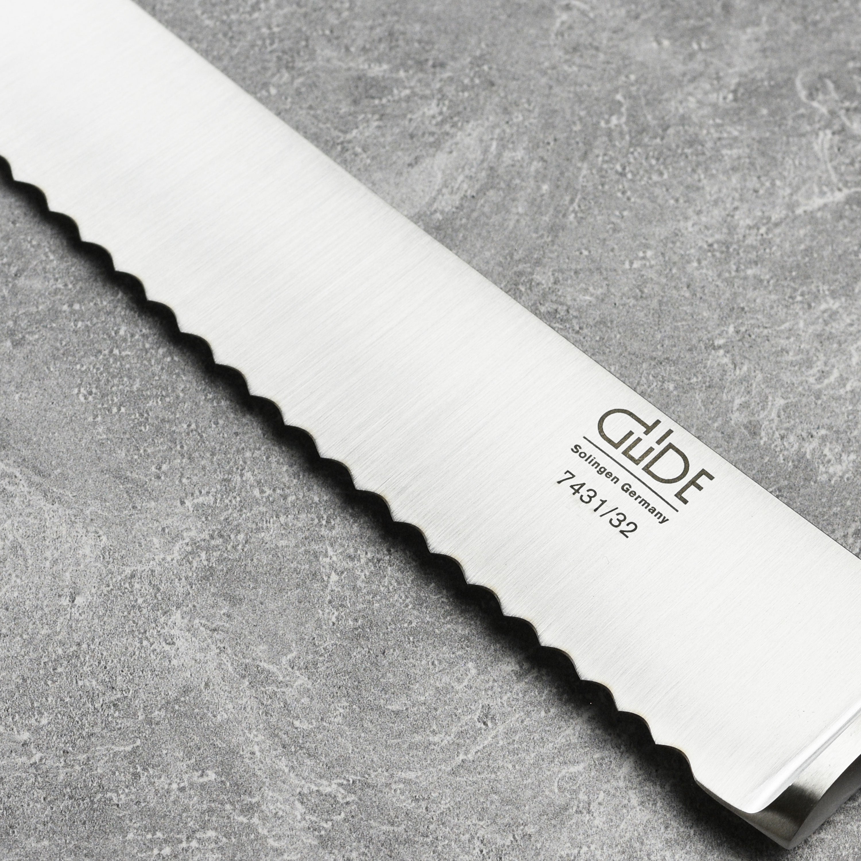 Elegant handcrafted bread knife with full bolster and full-tang olive wood handle
