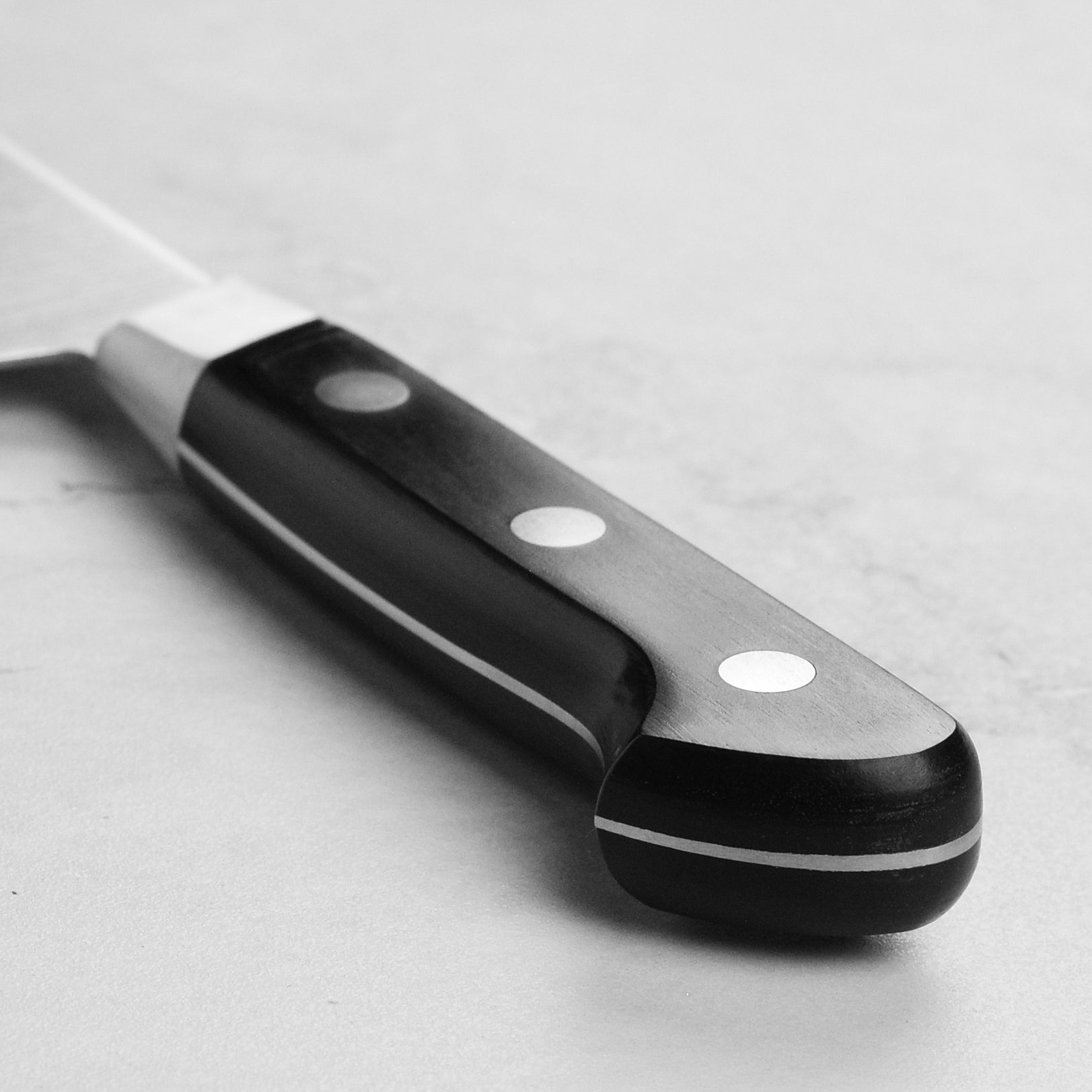 Close-up of the Misono UX10 Santoku knifes double-bevel edge, highlighting its sharpness and craftsmanship.